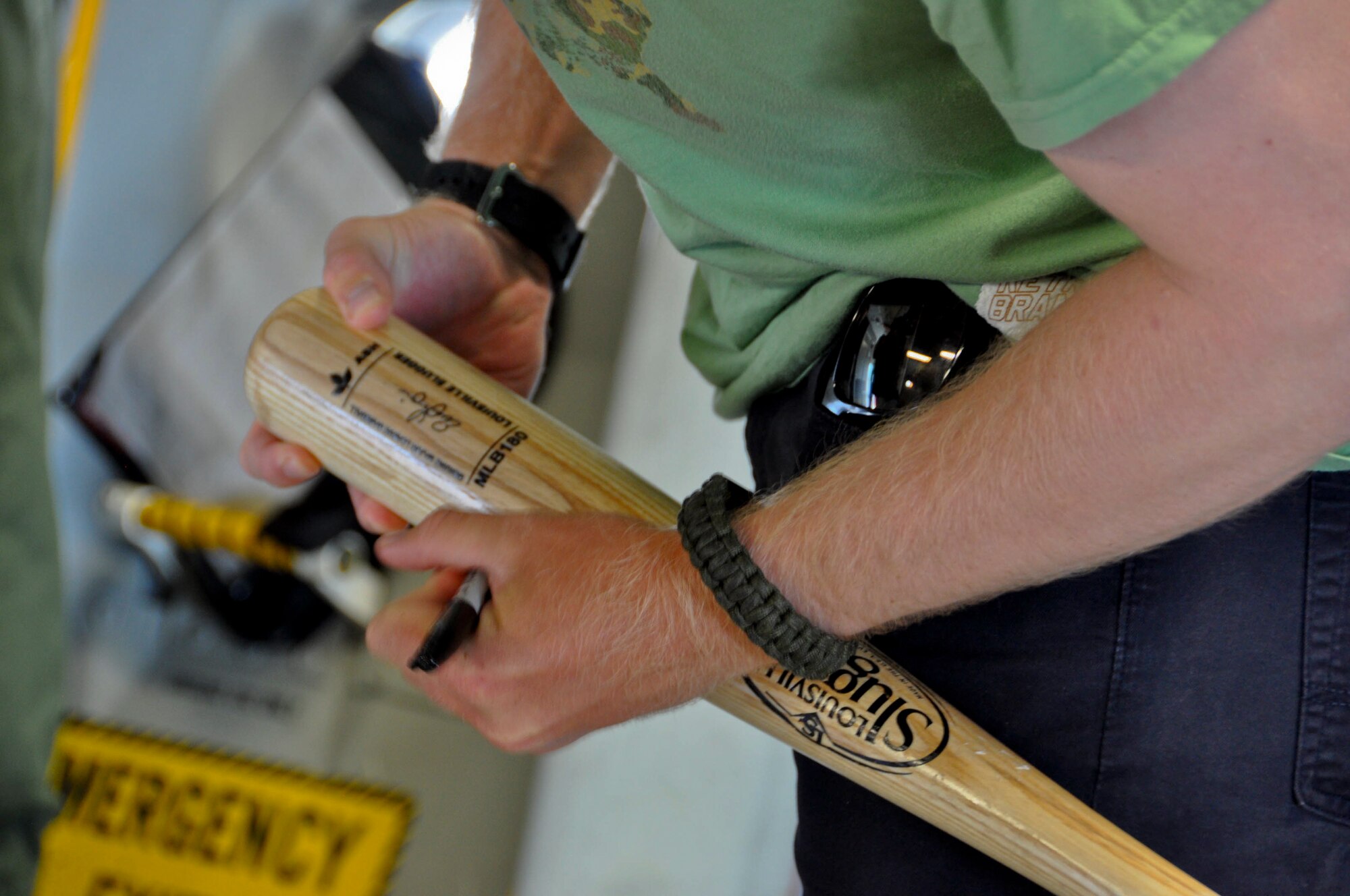 Sean Doolittle, Oakland A's pitcher, signs a baseball bat for an Airman July 21 at Travis Air Force Base. Doolittle toured Travis and signed memorabilia for fans along the way. (U.S. Air Force photo by Airman 1st Class Amber Carter)