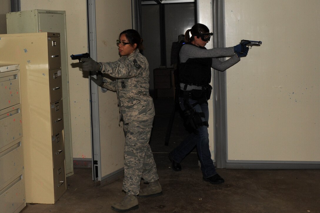 Staff Sgt. Tanya Jimenez, 28th Security Forces Squadron response force member, and April Miller, 28th SFS police officer, sweep a room during active shooter training as part of the Defender’s Edge program at Ellsworth Air Force Base, S.D., July 23, 2014. Defender’s Edge is designed to provide realistic training to security forces members and mentally and physically prepare them for various situations they may encounter. (U.S. Air Force photo by Senior Airman Hailey R. Staker/Released) 