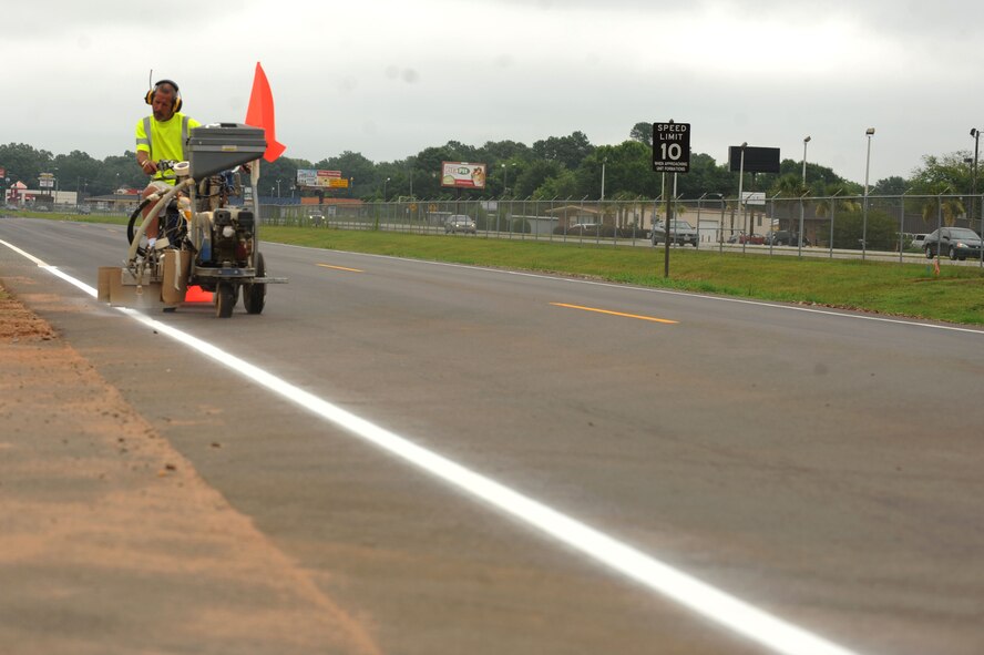 Chris Blankenship, East Coast Striping and Sealing line striper out of Clayton, N.C., drives a Line Striper to fill in the lines on Perimeter Road at Shaw Air Force Base, S.C., July 25, 2014. The company has helped paint roads on base for about two months. (U.S. Air Force photo by Senior Airman Ashley L. Gardner/Released) 