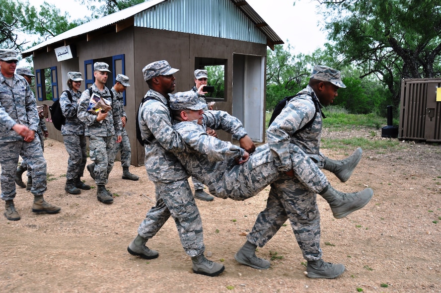 Chaplain candidates carry a simulated casualty at a simulated village at the Basic Expeditionary Airman Skills Training on July 24, 2014 at the Basic Expeditionary Airman Skills Training course. The candidate’s were visiting Air Force bases during a five week orientation to become chaplains in the Air Force.  (U.S. Air Force photo by Tech Sgt. Carlos J. Trevino)