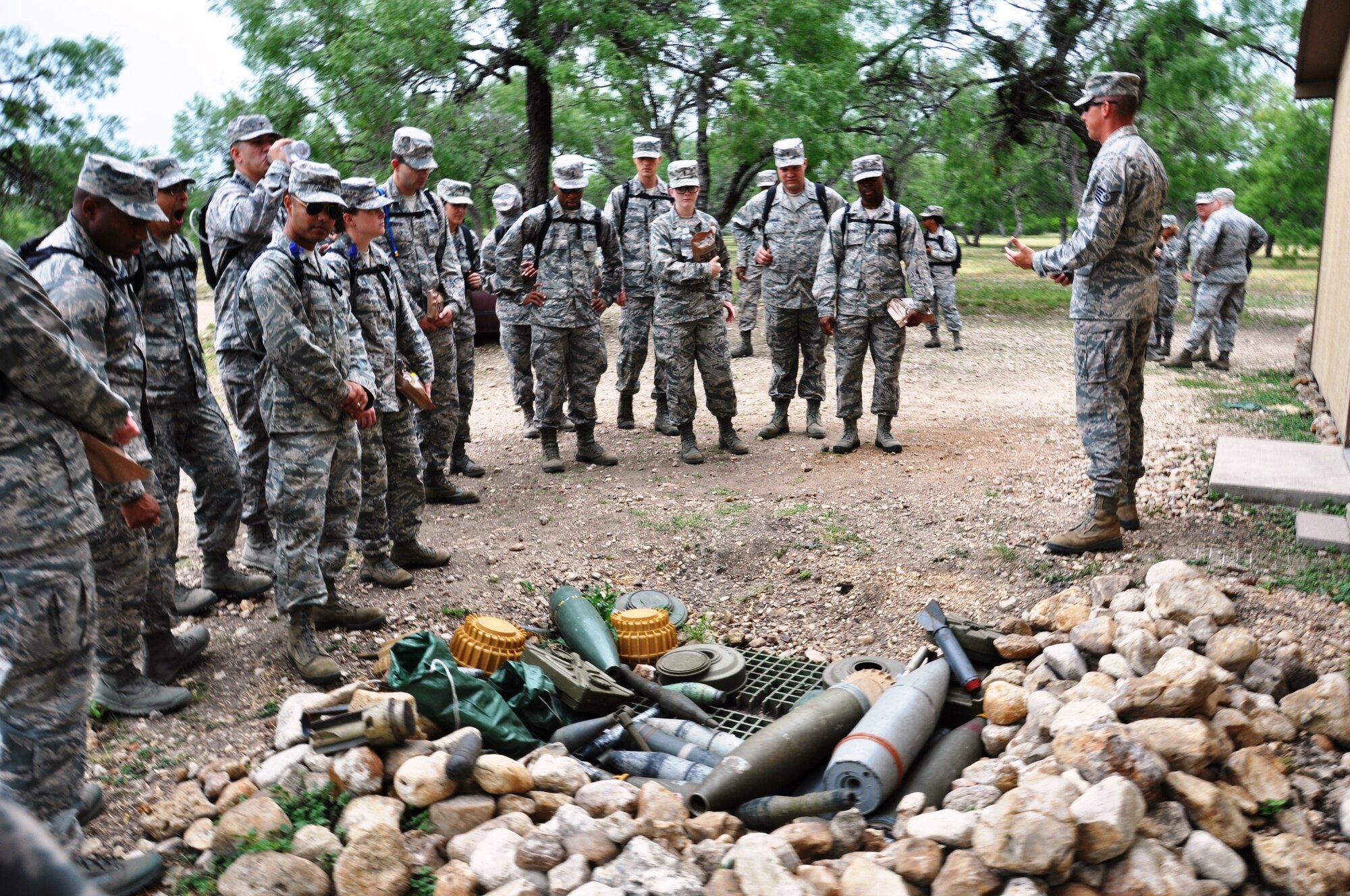 Tech Sgt. Christopher Spradley, military training instructor with the 319th Training Squadron, JBSA-Lackland, Texas, describes various training aides of improvised explosive devices at the Creating Leaders Airmen’s or “CLAW” for short, warrior’s site, July 24, 2014 at Joint Base San Antonio-Lackland.  (U.S. Air Force photo by Tech Sgt. Carlos J. Trevino)