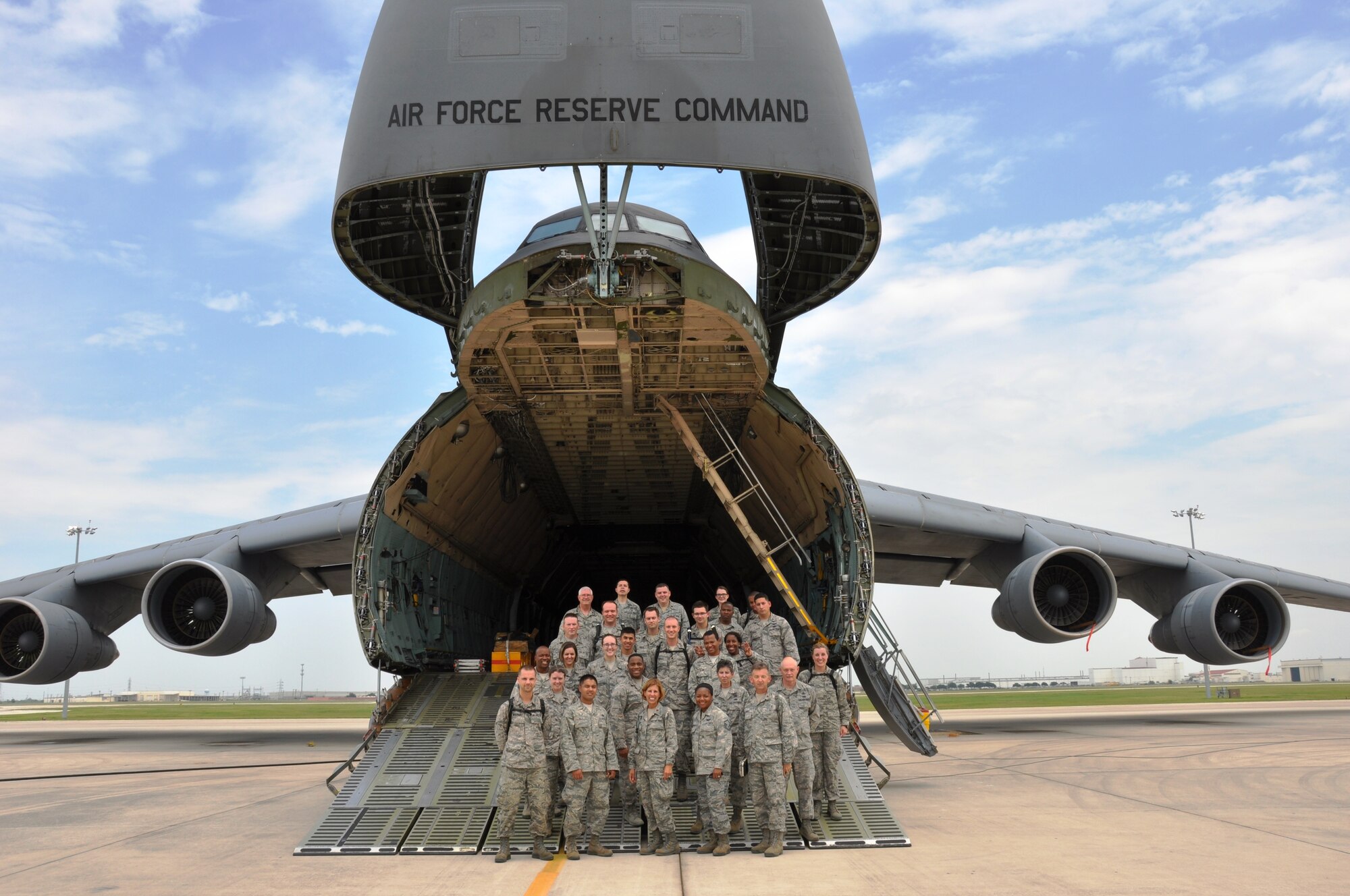 Air Force chaplain candidates and their escorts pose for a group photo on the ramp of a C-5A Galaxy aircraft at the 433rd Airlift Wing, July 24, 2014 at Joint Base San Antonio-Lackland. The Air Force Chaplain Candidate Program allows seminary and other professional religious school students to evaluate their compatibility and potential for commissioning as an Air Force Chaplain. Part of their indoctrination was visiting several Air Force Bases during a summer tour. (U.S. Air Force photo by Tech Sgt. Carlos J. Trevino)