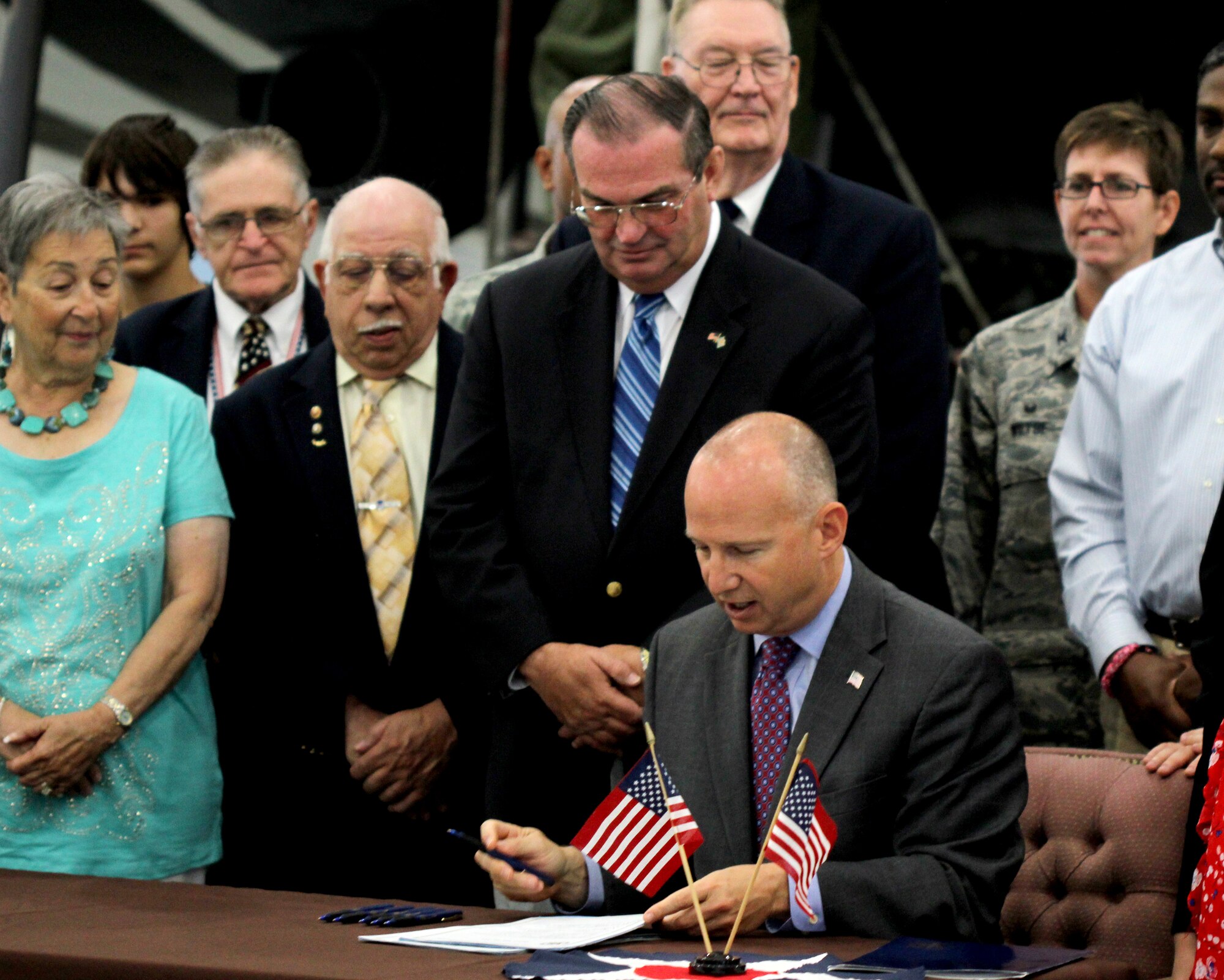 Col. Gretchen M. Wiltse, the 512th Mission Support Group commander, represents the 512th Airlift Wing at a bill signing event by Delaware Governor Jack A. Markell at the Air Mobility Command Museum, Dover Air Force Base, Del., July 21, 2014. One bill created a special motor vehicle license plate to honor the state's veterans, and the other signed bill is designed to assist service personnel and their spouses in obtaining or renewing professional licenses when transitioning. (U.S. Air Force photo/ Herbert E. Welday III)