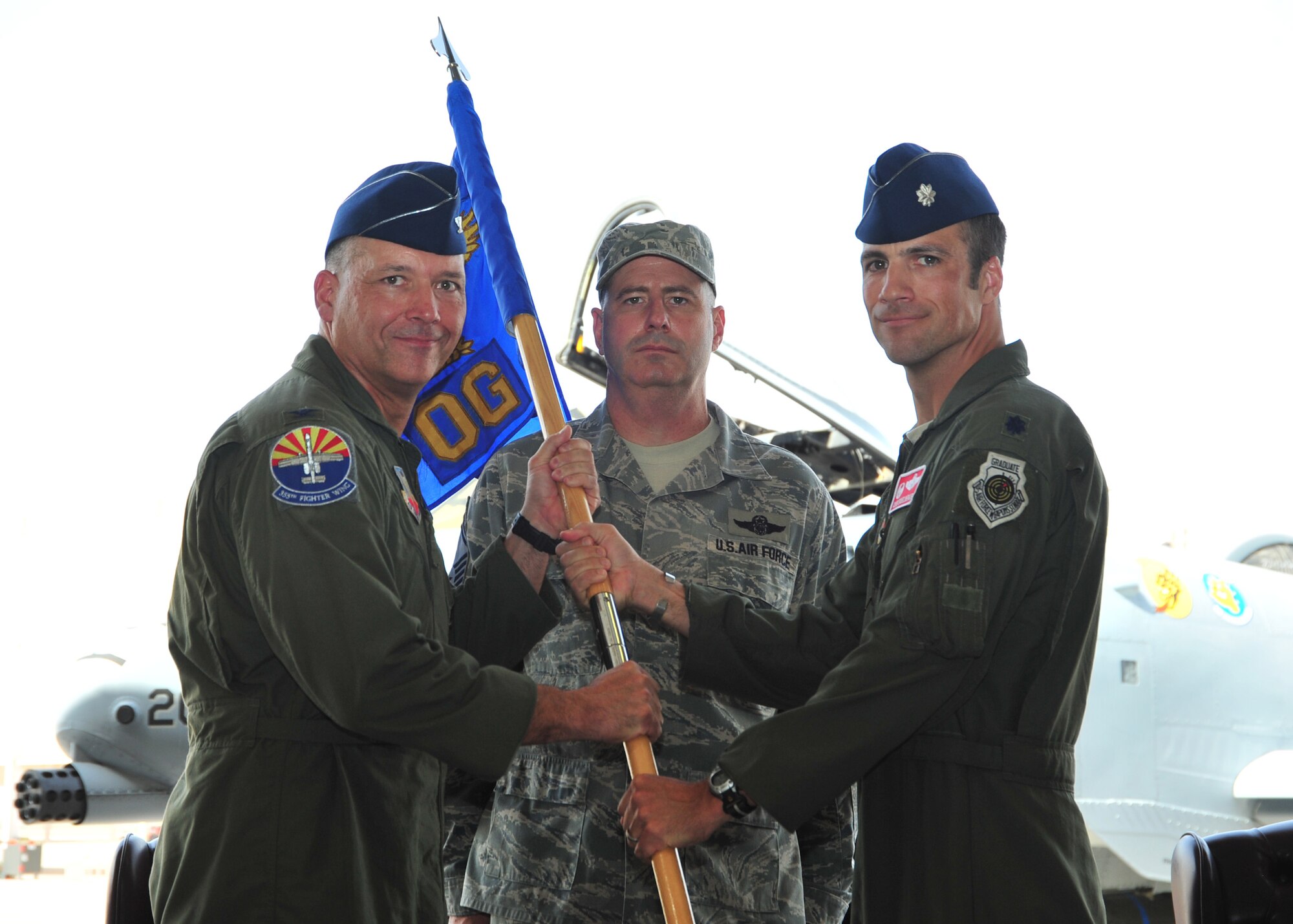 U.S. Air Force Lt. Col. Clinton W. Eichelberger accepts the 355th Operations Group guidon from Col. Kevin E. Blanchard, 355th Fighter Wing commander, during a change of command ceremony at Davis-Monthan Air Force Base, Ariz., July 24, 2014. The passing of the guidon is a traditional military custom signifying the transfer of command, thereby signifying Eichelberger’s new role as the 355th OG commander. (U.S. Air Force Photo by Airman 1st Class Chris Massey/Released)
