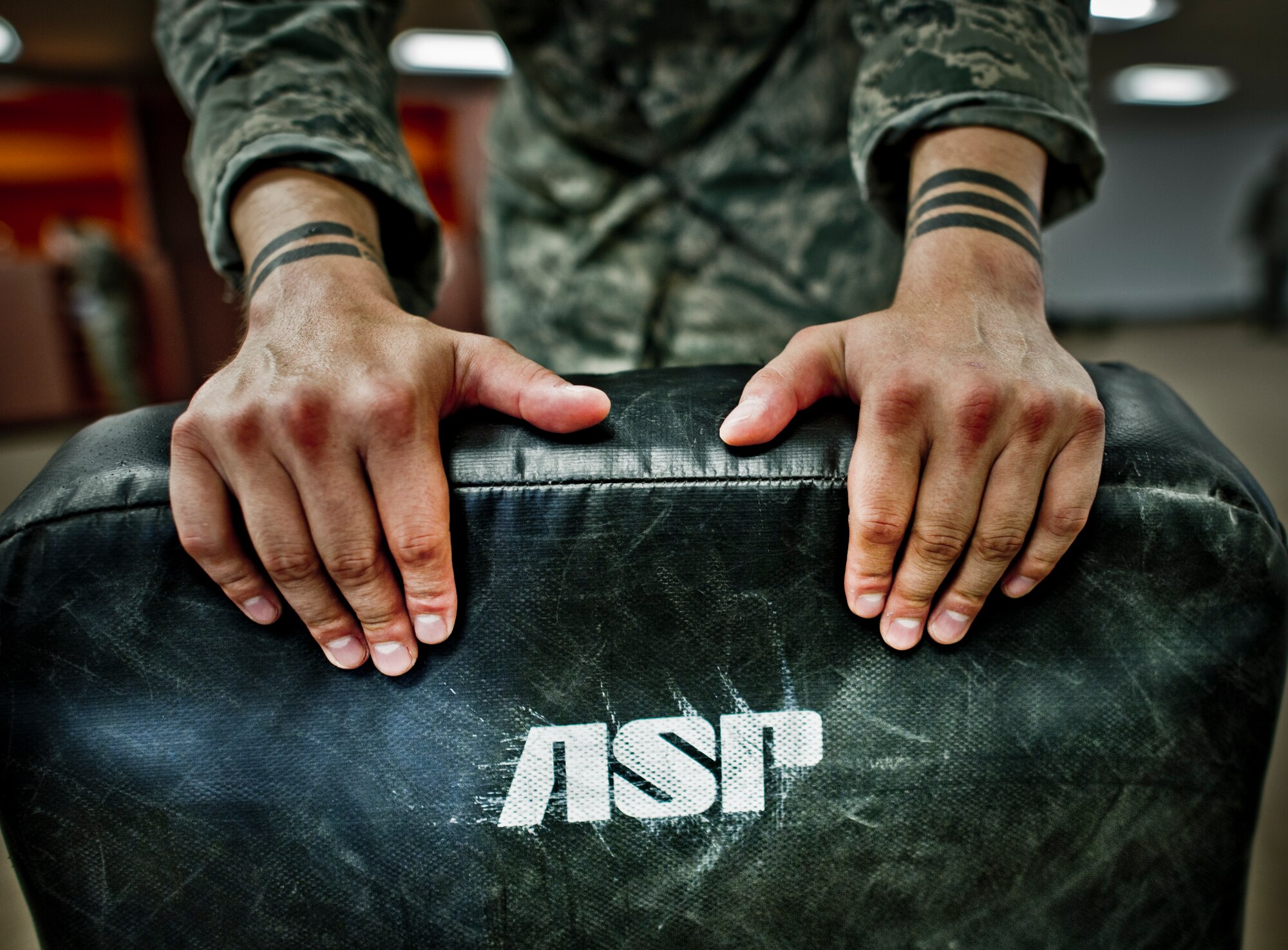 A member of the 49th Security Forces Squadron recovers from striking drills combatives training at Holloman Air Force Base, N.M., July 18. Security Forces combatives training is designed to equip SFS personnel with the knowledge and skills to respond to potentially deadly confrontations. It's a physically demanding 20-hour training block that encompasses both standing and ground offensive, defensive and apprehension techniques. (U.S. Air Force photo by Staff Sgt Stacy Moless/Released)