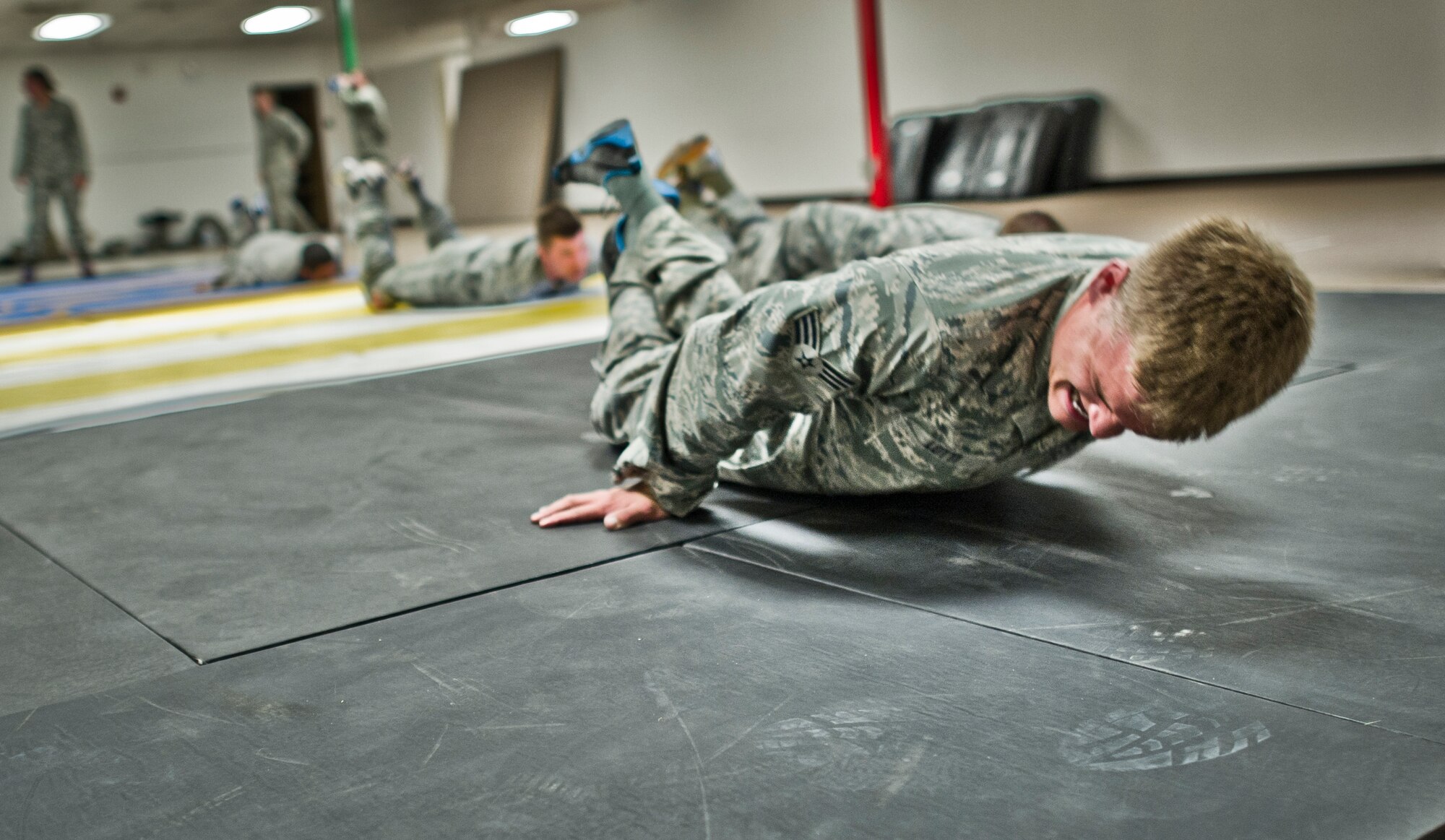Senior Airman Nicholas Lotti, 49th Security Forces Squadron, conducts mat grab pull during combatives training at Holloman Air Force Base, N.M., July 18. Security Forces combatives training is designed to equip SFS personnel with the knowledge and skills to respond to potentially deadly confrontations. It's a physically demanding 20-hour training block that encompasses both standing and ground offensive, defensive and apprehension techniques. (U.S. Air Force photo by Staff Sgt Stacy Moless/Released)
