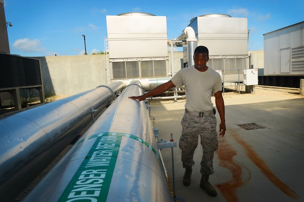 U.S. Air Force Senior Airman Jarell Rose, 20th Civil Engineer Squadron heating, ventilation, air conditioning and refrigerating journeyman, inspects a condensed water pipe at Shaw Air Force Base, S.C., July 23, 2014. During its inspection, Rose checks the pipe for any water leaks or metal corrosion. (U.S. Air Force photo by Airman 1st Class Jensen Stidham/Released)