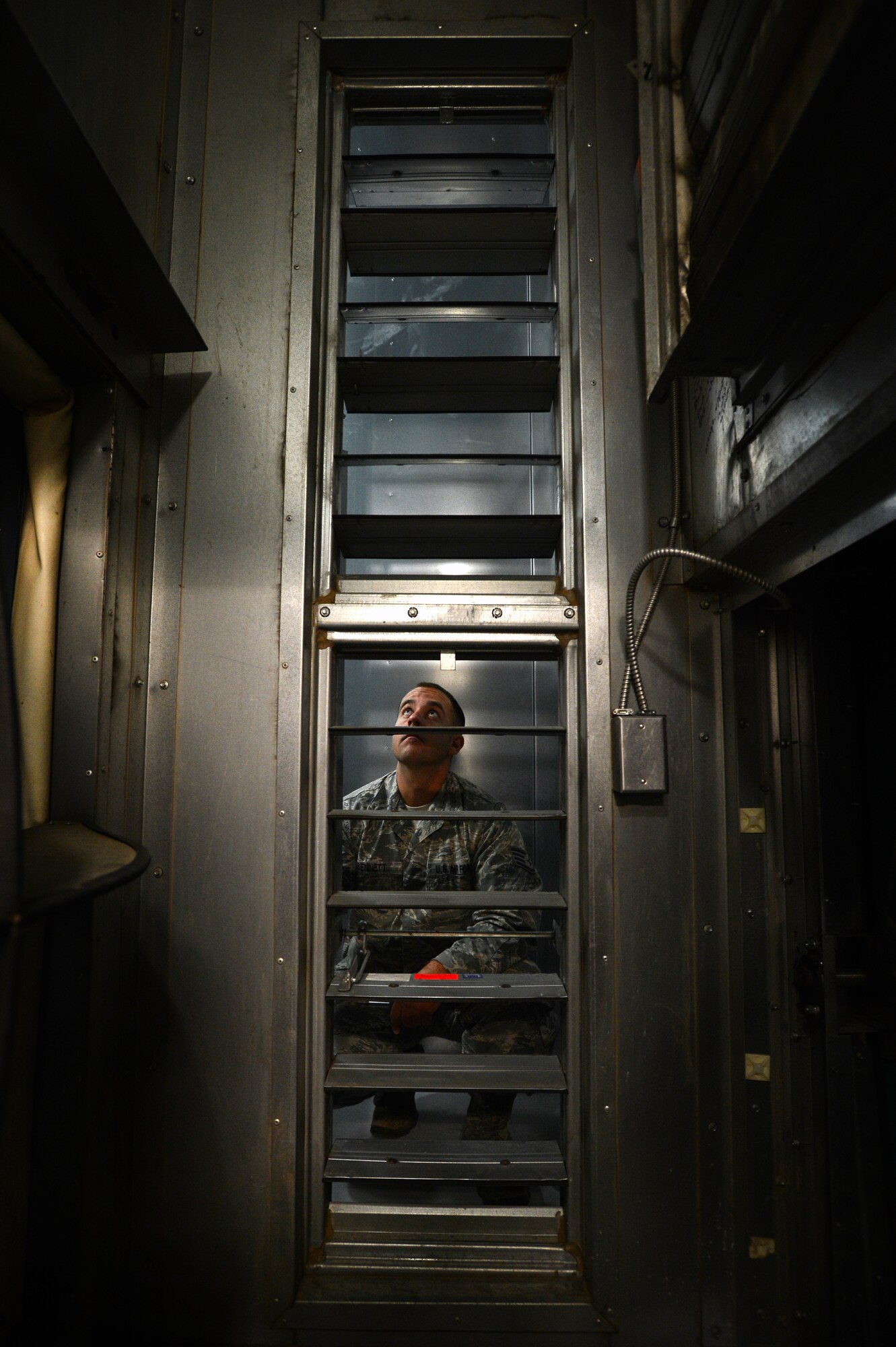 U.S. Air Force Staff Sgt. Nicholas Bennett, 20th Civil Engineer Squadron heating, ventilation, air conditioning and refrigerating craftsman, inspects a vent inside of a chiller at Shaw Air Force Base, S.C., July 22, 2014. The 140-ton chiller provides the Shaw Fitness and Health Center with approximately 55 degree air.