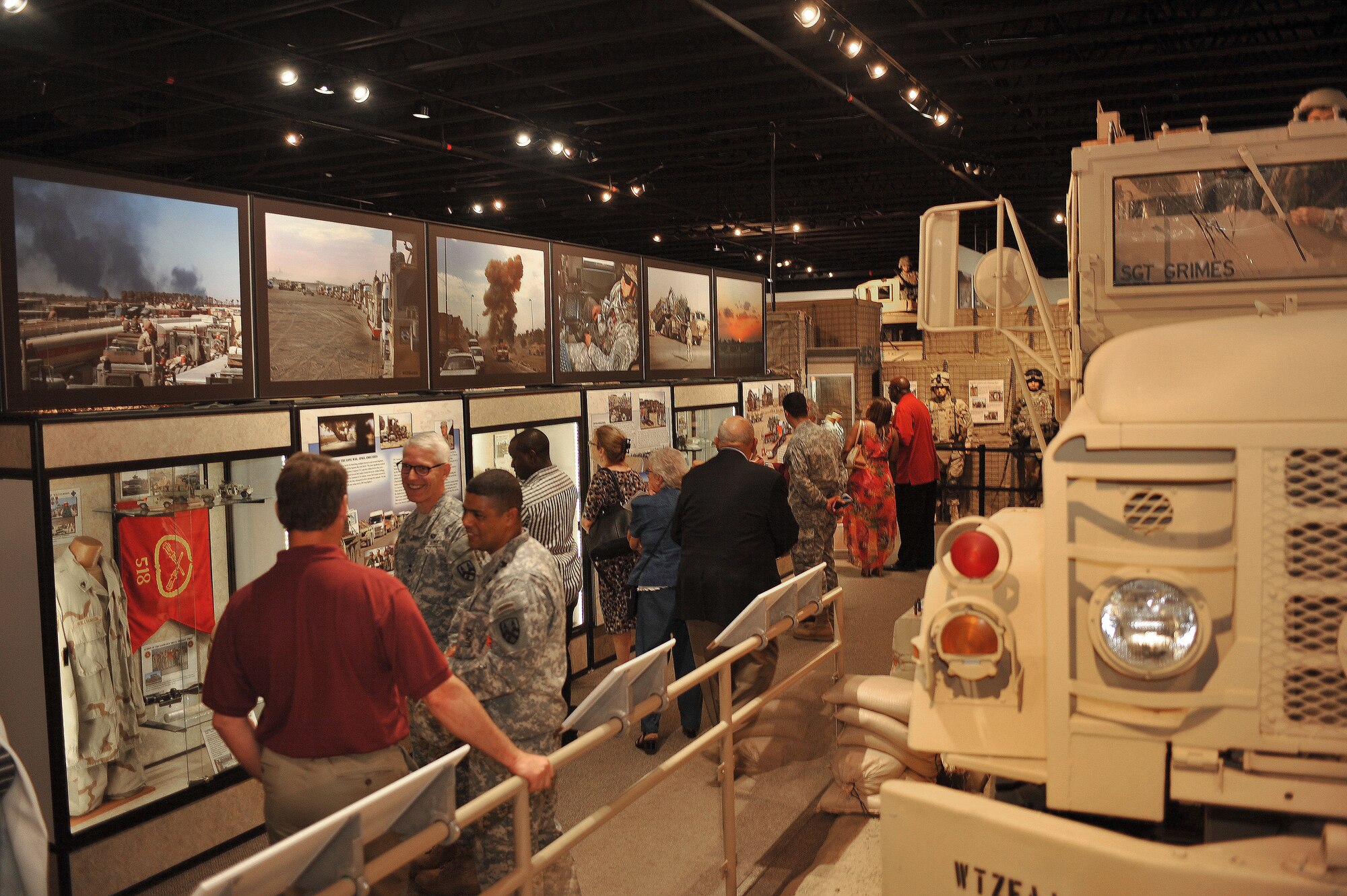 U.S. Army Transportation Museum patrons experience the newly-opened Operations Iraqi and Enduring Freedom exhibit during the museum’s ribbon-cutting ceremony at Fort Eustis, Va., July 24, 2014. The new 5,000-square-foot gallery is expanded from its previous 1,200 square feet, and transitions from Desert Shield and Desert Storm through 10 years in Iraq and Afghanistan. (U.S. Air Force photo by Staff Sgt. Katie Gar Ward/Released)