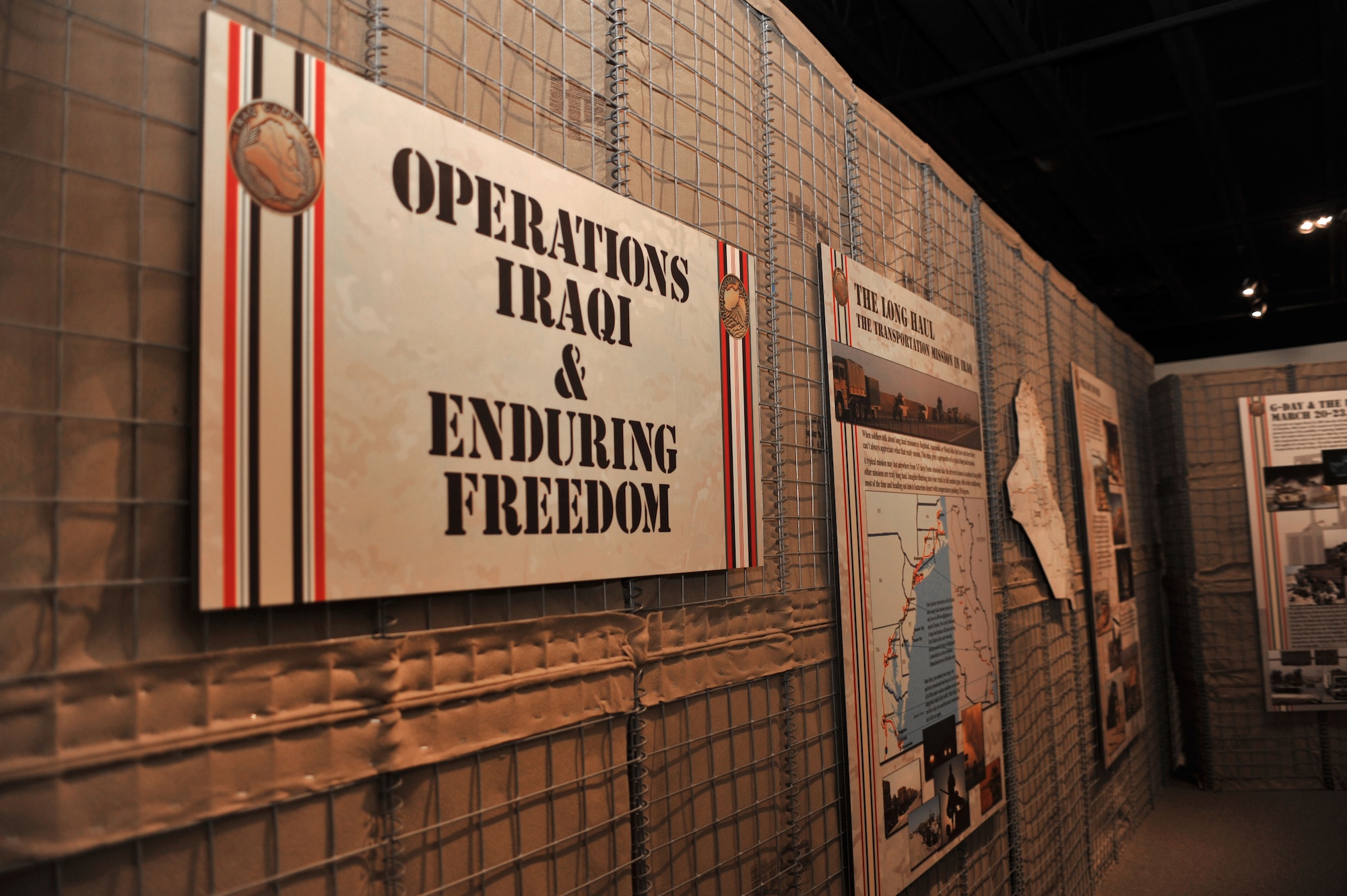 In celebration of the U.S. Army Transportation Corps’ 72nd birthday, the Army Transportation Museum hosted an opening for its new exhibit featuring Operations Enduring and Iraqi Freedom and Operation New Dawn.  The 5,000-square-foot gallery took more than 18 months to complete and features newer artifacts and advanced, interactive audio and visual technologies. (U.S. Air Force photo by Staff Sgt. Katie Gar Ward/Released)
