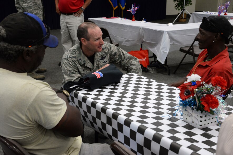 U.S. Air Force Col. Stephen Jost, 20th Fighter Wing commander, speaks to two attendees of the Ability One employee appreciation picnic at Shaw Air Force Base, S.C., July 25, 2014. Jost went around before lunch was served to speak to many employees of the Ability One program and thank them for taking care of his Airmen. (U.S. Air Force photo by Airman 1st Class Jonathan Bass/Released)