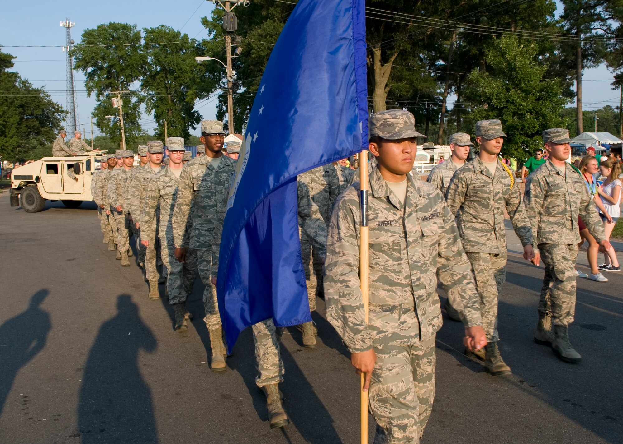 Airman Renald Rivera, 373d Training Squadron C-5M Super Galaxy crew chief student, carries a U.S. Air Force flag while leading a formation of Team Dover Airmen during a parade at the Delaware State Fair July 23, 2014, at the Delaware State Fairgrounds in Harrington, Del. More than 40 Airmen took part in the parade. (U.S. Air Force photo/Airman 1st Class Zachary Cacicia)