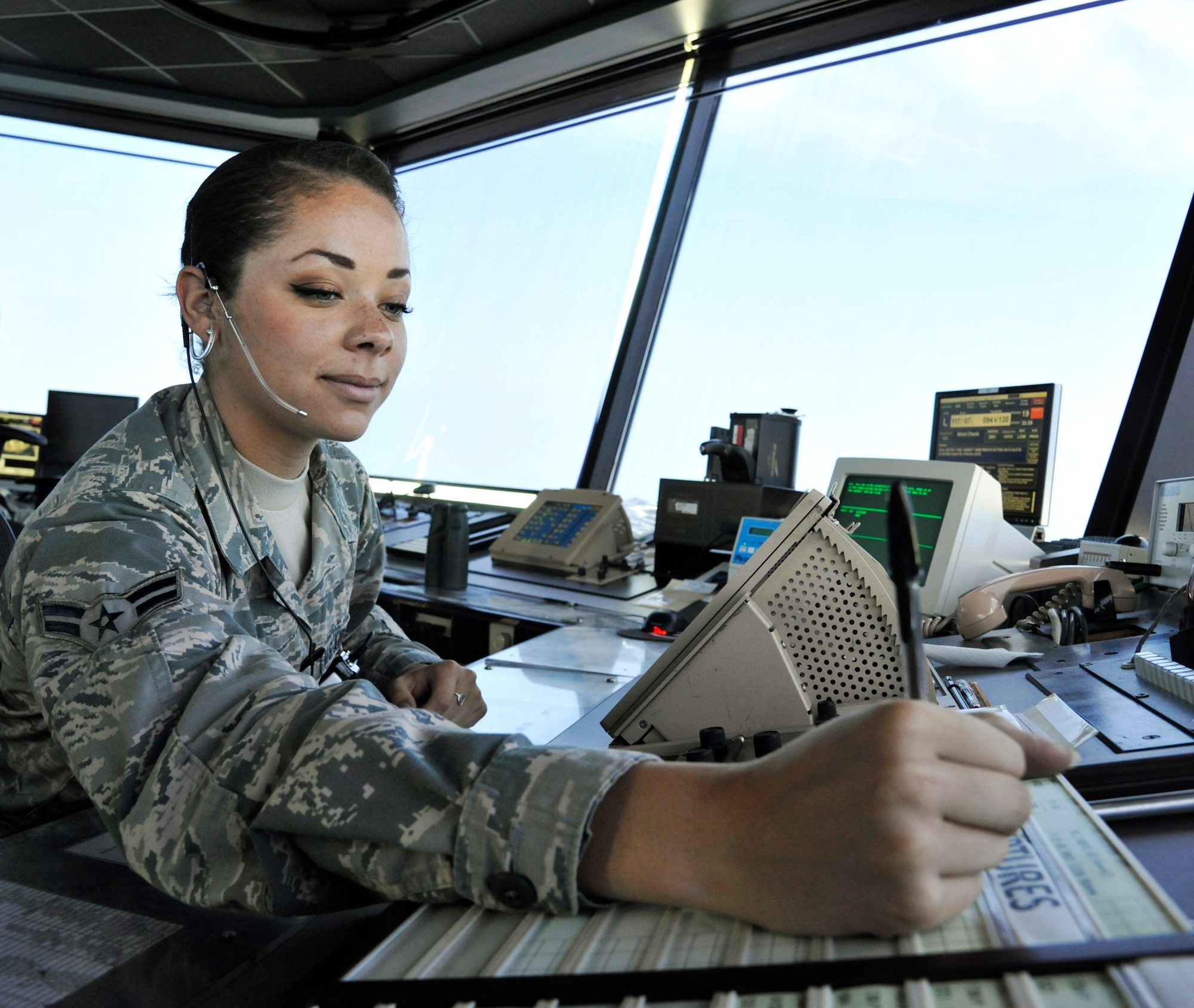 U.S. Air Force Airman 1st Class Chanel Johnson, 509th Operations Support Squadron air traffic control apprentice, writes on a flight progress strip at Whiteman Air Force Base, Mo., July 10, 2014. Flight progress strips are used to keep track of aircraft missions, and contain the aircraft name, type, departure time and instructions for landing. (U.S. Air Force photo by Airman 1st Class Keenan Berry/Released)