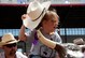 140724-F-GZ967-037 Morgan Krul, 8, raises her cowboy hat as she rides a modified, mechanical bull during the 2014 Cheyenne Frontier Days Challenge Rodeo July 24. The Challenge Rodeo provides children with special needs to participate in various western activities, including steer roping, horseback riding and barrel racing. (U.S. Air Force photo by Airman 1st Class Brandon Valle)