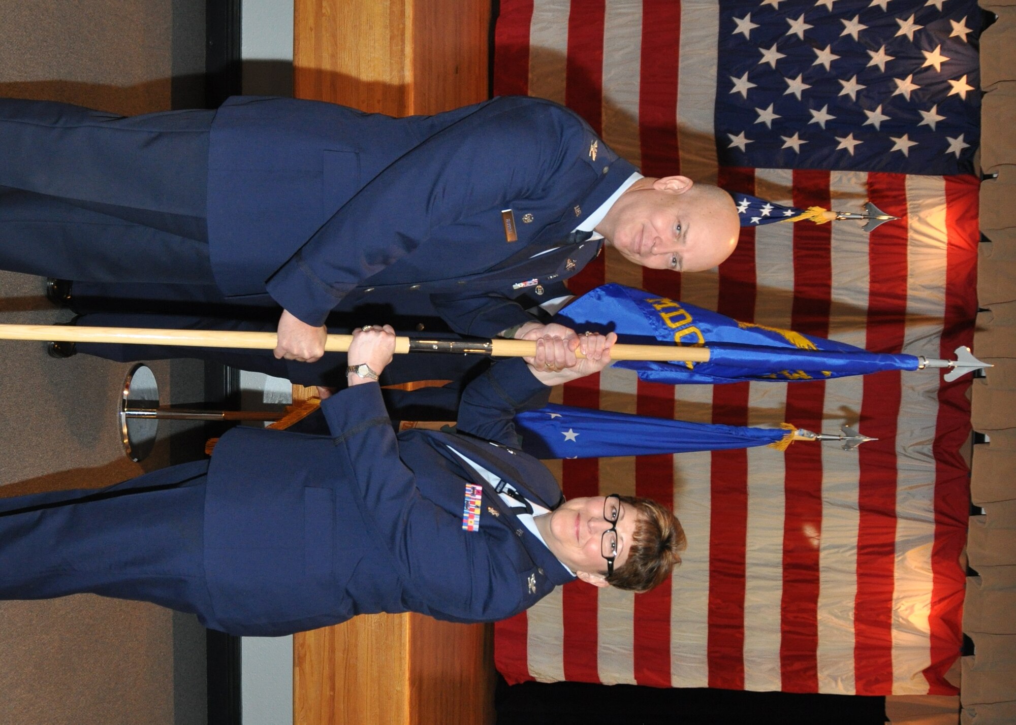 Lt. Col. MiMi Cannonier accepts command of the 81st Inpatient Operations Squadron during anassumption of command ceremony July 1 in the Keesler Medical Center’s Don Wylie Auditorium.  Col. (Dr.) Tom Harrell, 81st Medical Group commander officiated the ceremony.  She succeeds Col. Jerry Lawson who retired after 23 years of Air Force service. (U.S. Air Force photo by Steve Pivnick)