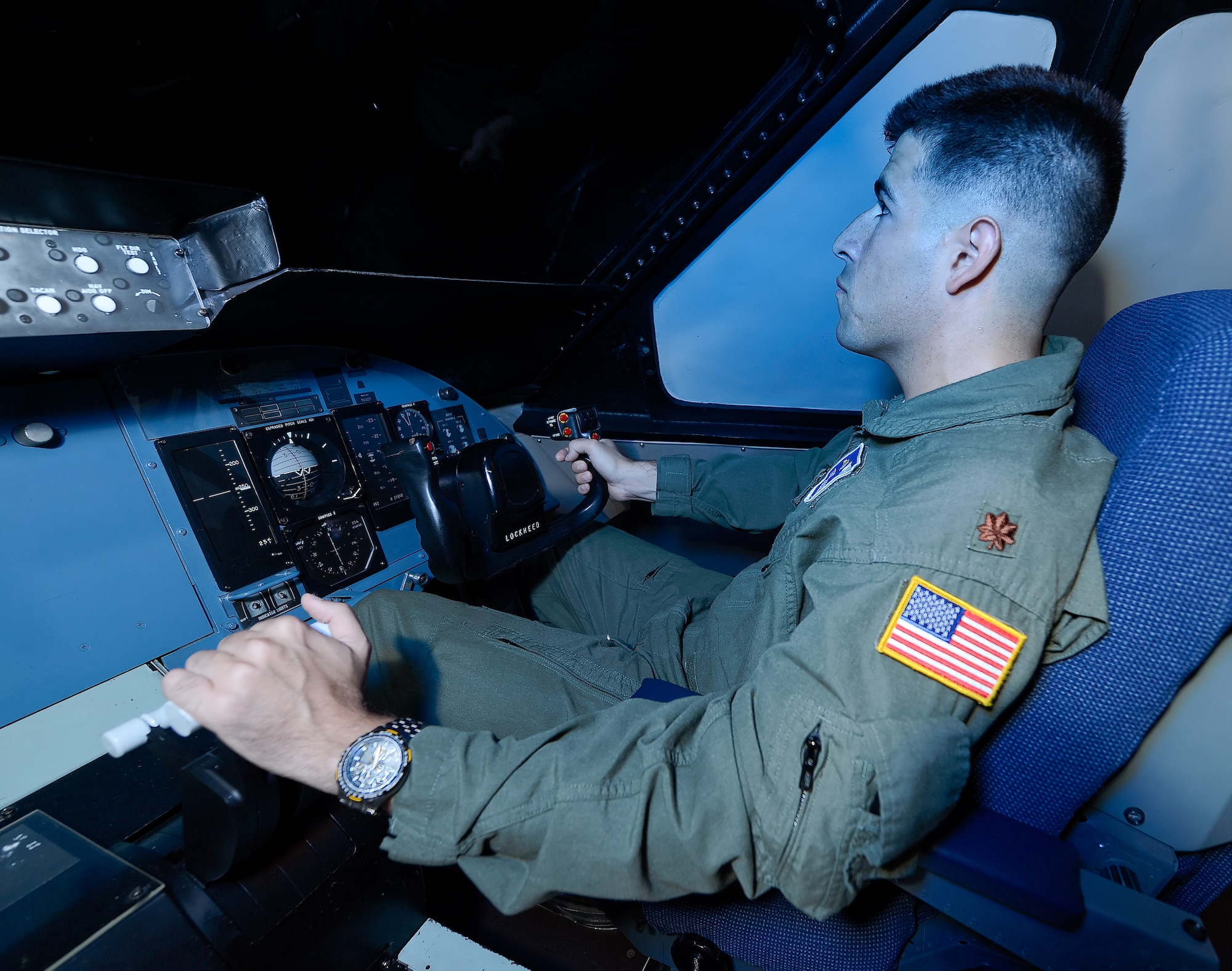 Maj. Thomas Moseder, a C-5M instructor pilot, concentrates while practicing air-refueling training inside the C-5 Air Refueling Partial Task Trainer July 23, 2014, at Dover Air Force Base, Del. The AR PTT is unlike full-motion simulators where the cockpit in which the pilot is seated moves. Instead, the visuals presented to the pilot are produced by moving a large model in relation to refraction lenses, mirrors and a lighting array to provide a very realistic experience at low cost. (U.S. Air Force photo/Greg L. Davis)