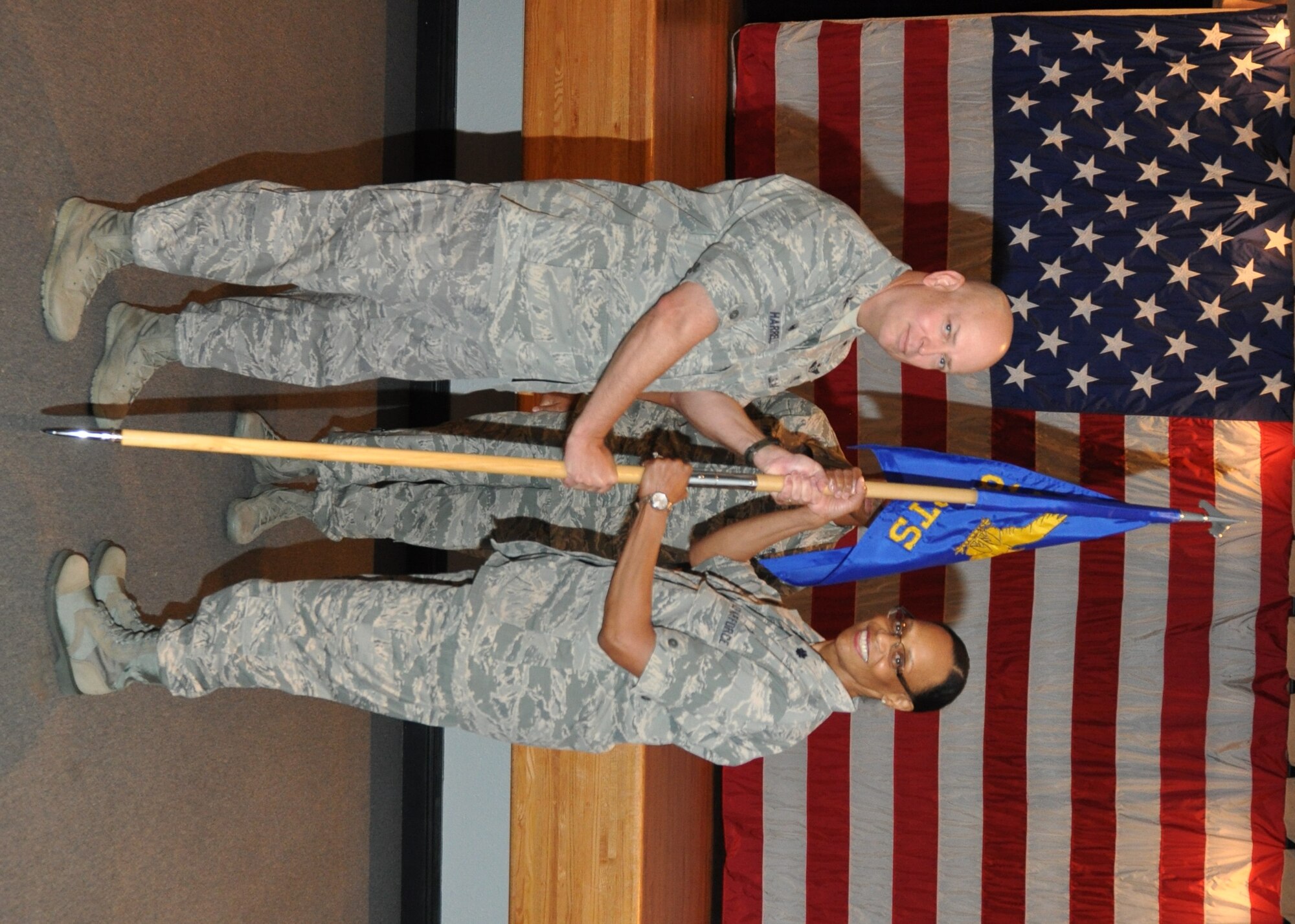 Lt. Col.  Maureen Harback takes command of the 81st Diagnostics and Therapeutics Squadron from current commander Col. Thomas Bacon during an ceremony July 1, 2014 at the Keesler Medical Center.  Col. (Dr.) Tom Harrell, 81st Medical Group commander officiated the ceremony.  Bacon will become commander of the 99th Medical Operations Squadron at Nellis Air Force Base, Nev. (U.S. Air Force photo by Steve Pivnick)