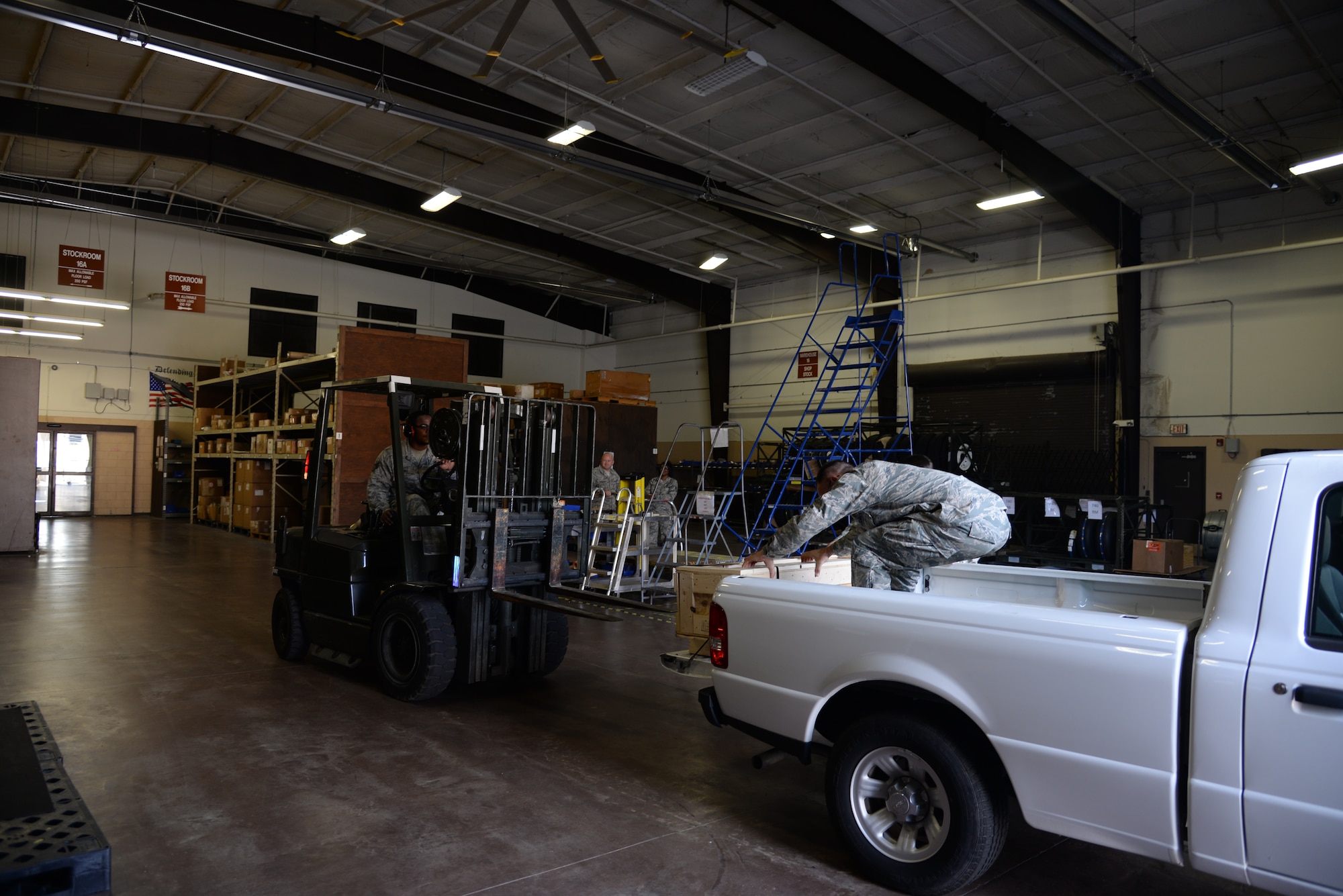 U.S. Air Force Staff Sgt. Kenrick Mendez, 23d Logistics Readiness Squadron aircraft store supervisor, uses a forklift to deliver a piece of support equipment to Tech. Sgt. Christopher McClure, 23d Equipment Maintenance Squadron aerospace ground equipment craftsman, July 24, 2014 at Moody Air Force Base, Ga. The part store manages 317,000 critical aircraft parts and Airborne Mobility Readiness Spare Packages worth $122 million. (U.S. Air Force photo by Airman 1st Class Sandra Marrero/Released)
