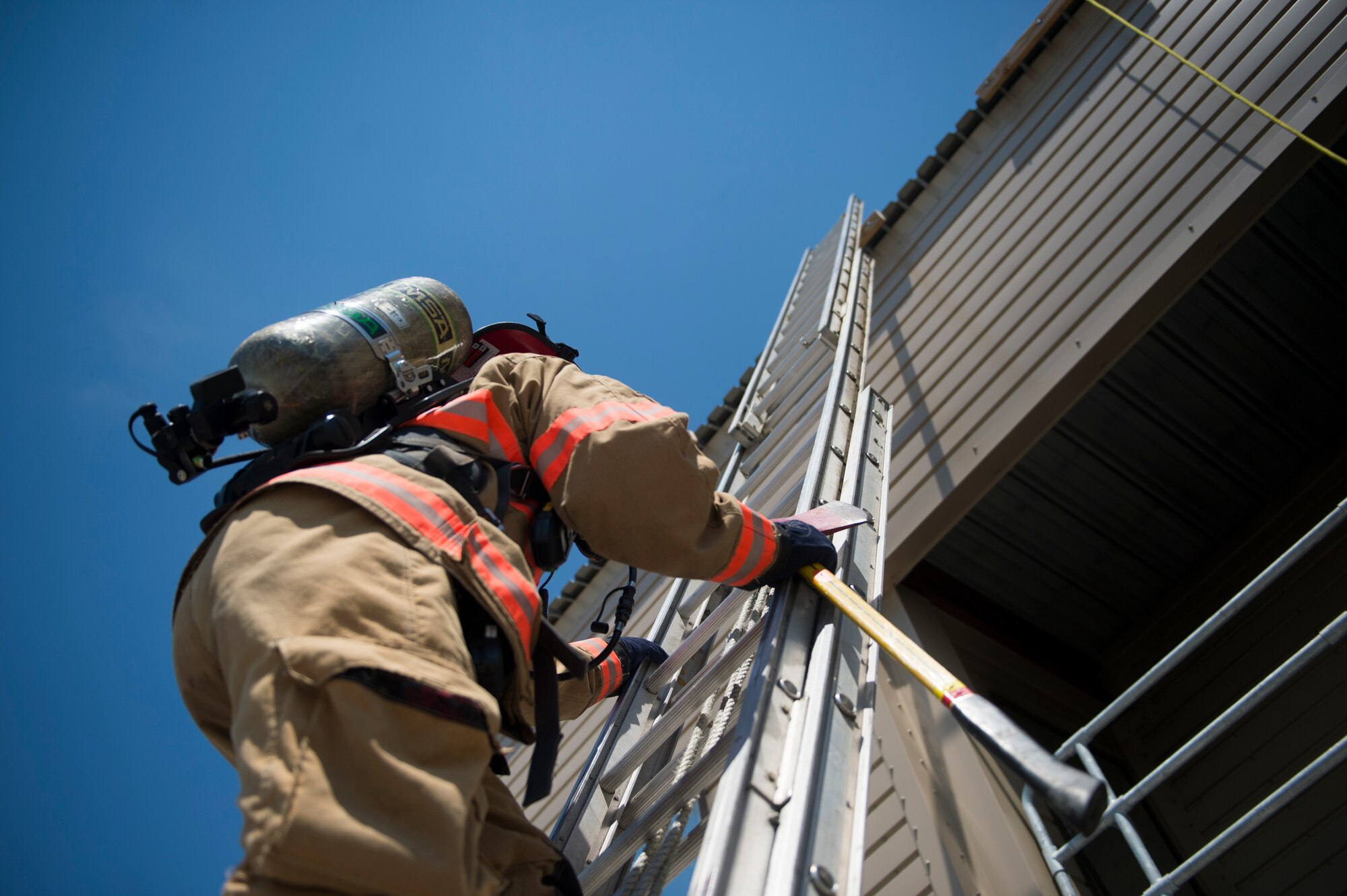 A Hurlburt Field firefighter climbs a ladder during training on Hurlburt Field, Fla., July 17, 2014. The department responds to calls on and off base and train frequently to maintain the proper skills to save lives. (U.S. Air Force photo/Senior Airman Christopher Callaway) 