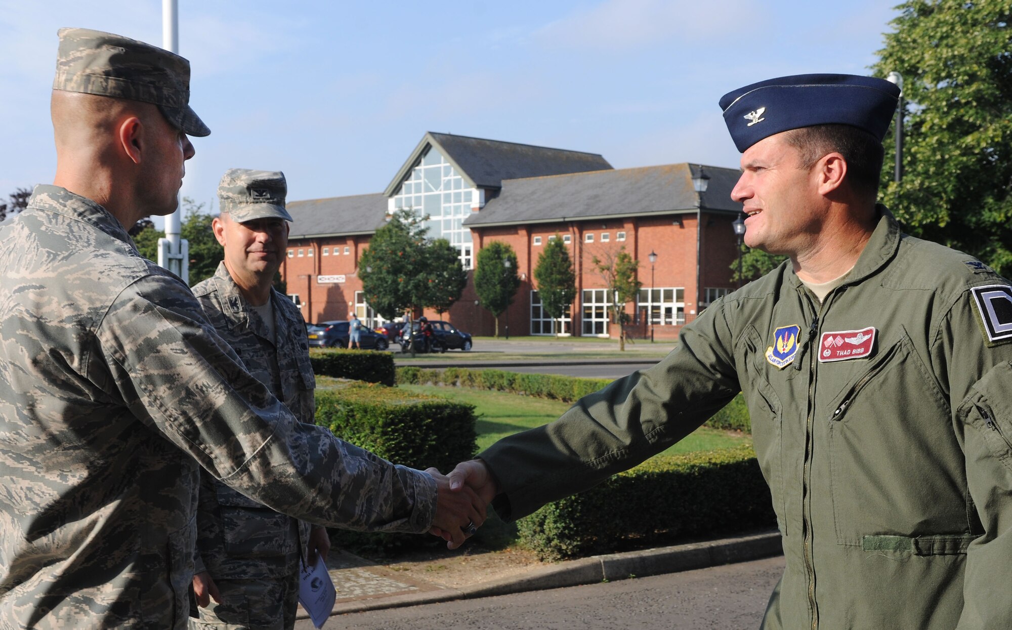 U.S. Air Force Col. Kenneth T. Bibb, Jr., 100th Air Refueling Wing commander, and U.S. Air Force Col. David Avila, 100th Mission Support Group commander, greet U.S. Air Force Brig. Gen. Bradley Spacy, U.S. Air Forces in Europe and Air Forces Africa director of logistics, installations and mission support, July 25, 2014, upon his arrival to RAF Mildenhall, England. Spacy toured a variety of units including the 352nd Special Operations Group, 100th Maintenance Group, 100th Security Forces Squadron, 100th Logistics Readiness Squadron fuels section, 100th Civil Engineer Squadron Airfield Lighting and the 100th CES Fire Department. (U.S. Air Force photo/Senior Airman Kate Maurer/Released)