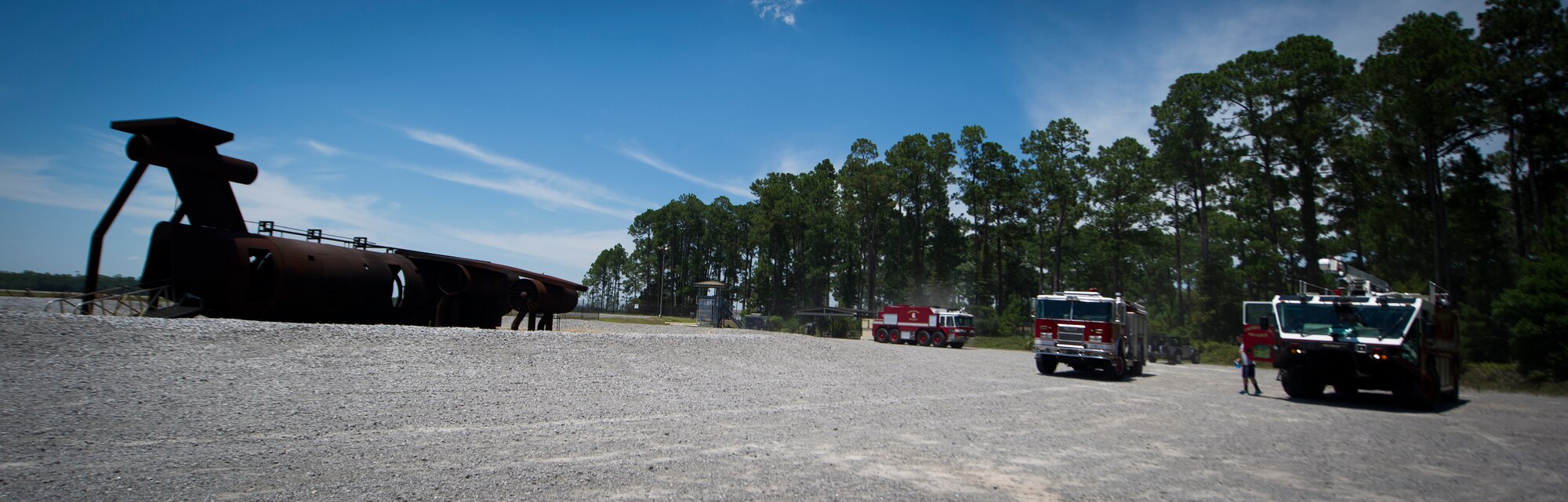 Hurlburt Field firefighters arrive at a training sight on Hurlburt Field, Fla., July 17, 2014. The Airmen conducted ventilation training to practice releasing smoke from a burning building. (U.S. Air Force photo/Senior Airman Christopher Callaway) 