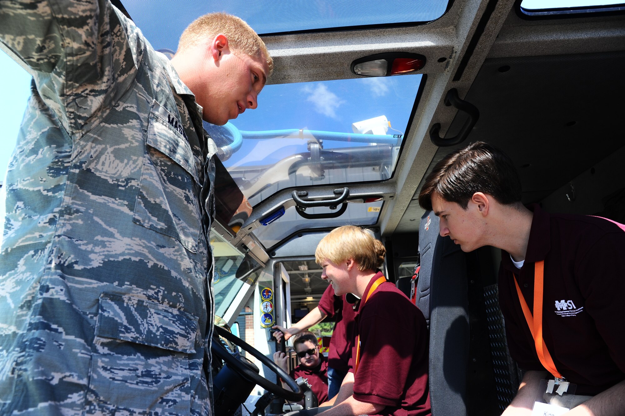 Airman 1st Class Seth Massey, 14th Civil Engineer Squadron Fire Protection, shows Mississippi Summer Transportation Institute students the inside of a fire truck on Columbus AFB, July 16. Students toured the fire station, engine maintenance, control tower and RAPCON. (U.S. Air Force photo/Airmen 1st Class Daniel Lile)
