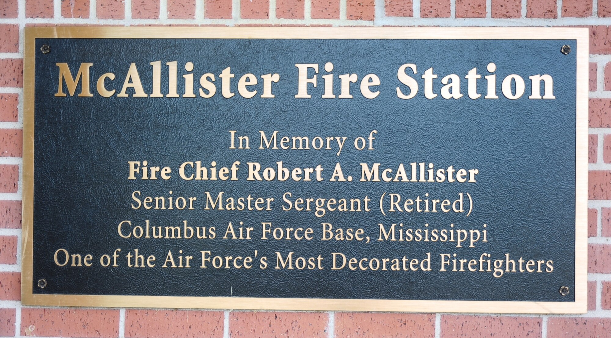 A plaque hangs near the door to the Columbus Air Force Base Crash and Fire Station dedicating the building to Senior Master Sgt. Robert McAllister, a very highly decorated firefighter with more than 50 years of military and government service. In his military career alone, he earned 33 Air Medals, the Silver Star, two Bronze Stars, six Meritorious Service Medals, six Air Force Commendation Medals and the Vietnamese Medal of Honor for training Vietnamese firefighters. (U.S. Air Force Photo/ Airman John Day)