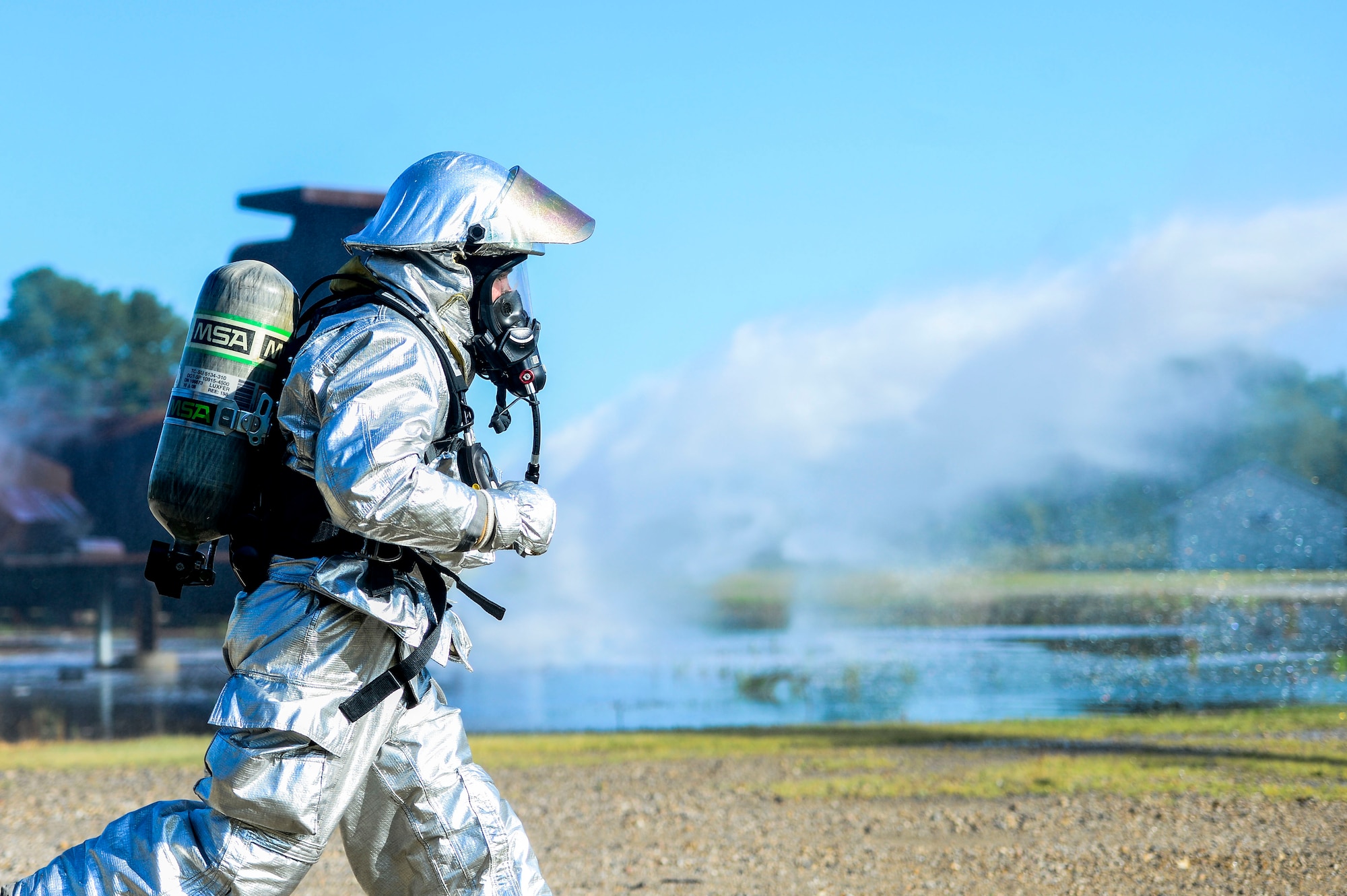 A U.S. Air Force Airman assigned to the 633rd Civil Engineer Squadron rushes to get equipment during an exercise at Langley Air Force Base, Va., July 25, 2014. The exercise tested the City of Hampton and Langley’s ability to work together while responding to an F-22 Raptor and T-38 Talon aircraft crash. (U.S. Air Force photo by Senior Airman Kayla Newman/Released)  