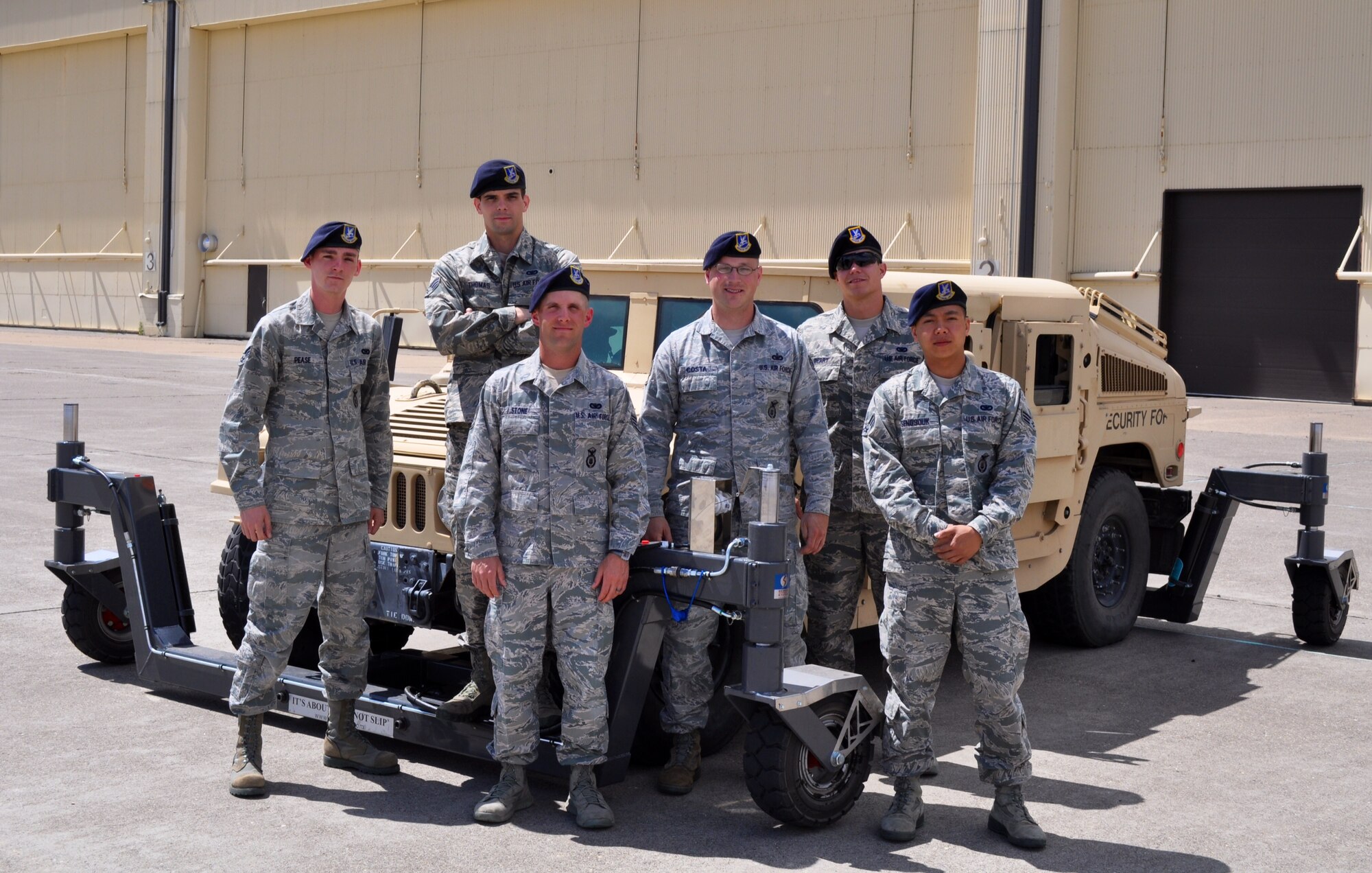 Security Forces Airmen pose with a skid trainer at Malmstrom Air Force Base, Montana, June 27. Three skid trainers were recently delivered to Air Force Global Strike Command to complement AFGSC's new driver safety program, familiarizing Airmen with the handling characteristics of the HMMWV in a wide variety of driving conditions.