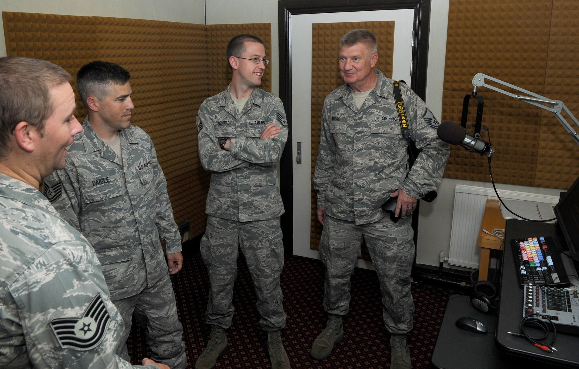 U.S. Air Force Tech. Sgt. Lance Daigle, second from left, American Forces Network-UK broadcast journalist from Eunice, La., shows Oklahoma Air National Guard Public Affairs Airmen from Altus Air Force Base, Okla., AFN-UK’s sound booth during a tour July 23, 2014, on RAF Feltwell, England. The Air National Guard doesn’t have AFN because AFN is strictly based overseas and, unless deployed or at a temporary duty assignment overseas, ANG Airmen are all stationed state-side. Therefore ANG broadcast journalists don’t have an opportunity to participate in radio broadcasting, aside from their technical training at the beginning of their careers. (U.S. Air Force photo/Senior Airman Kate Maurer/Released)