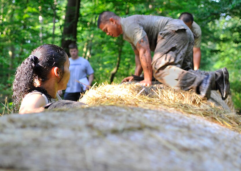Participants climb over a hay bale obstacle during the Mudless Mudder on June 19, 2014 at Ramstein Air Base, Germany. Teams were rated on the amount of time it took to get through the course as well as the number of penalties received during each obstacle. (U.S. Air Force photo/Airman Larissa Greatwood)