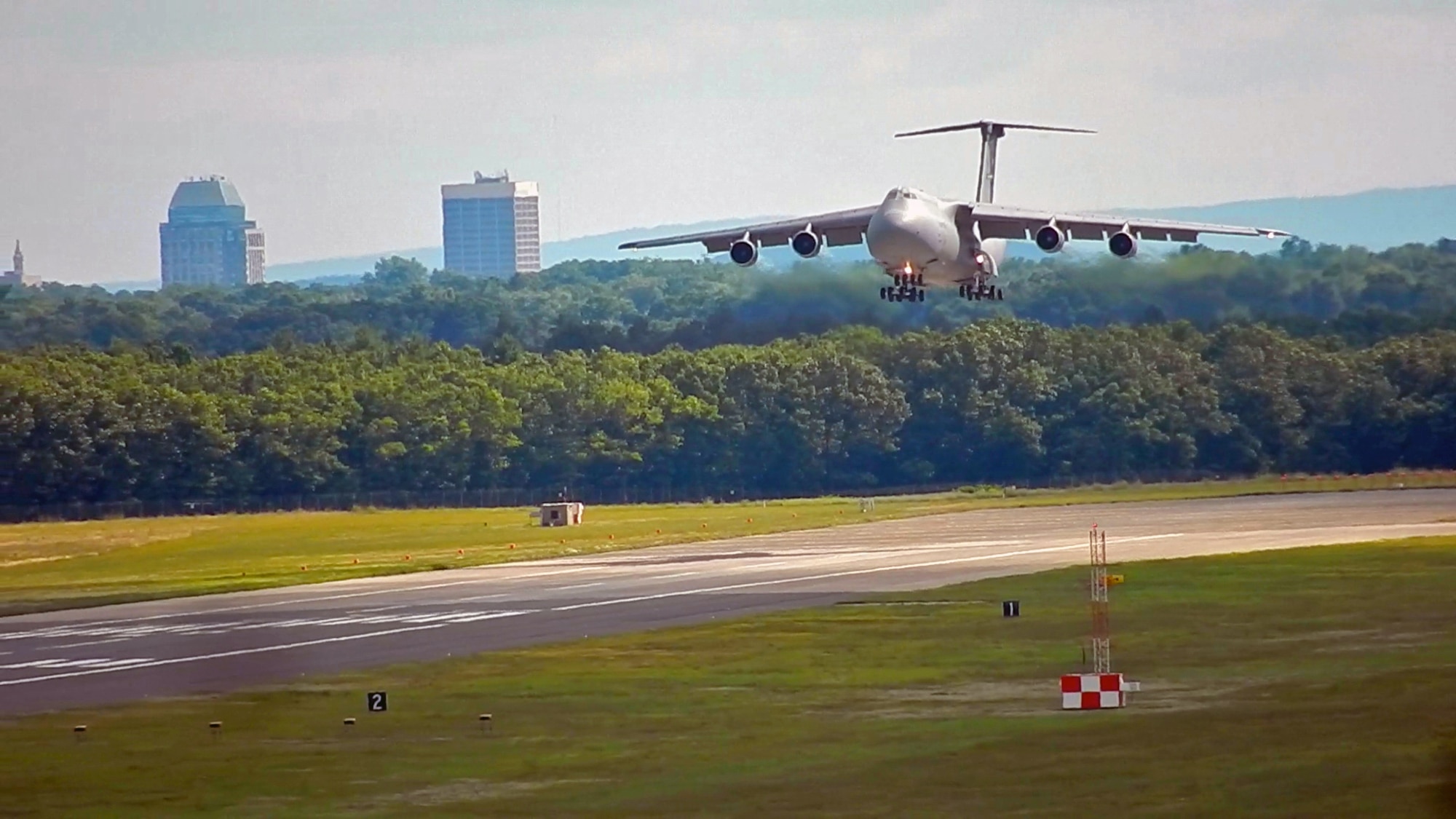 A C-5 Galaxy assigned to JB San Antonio-Lackland, Texas, comes in for a landing at Westover Air Reserve Base, Mass. July 24, 2014. The city of Springfield can be see in the background as the massive aircraft approaches the runway. (U.S. Air Force photo/W.C. Pope)