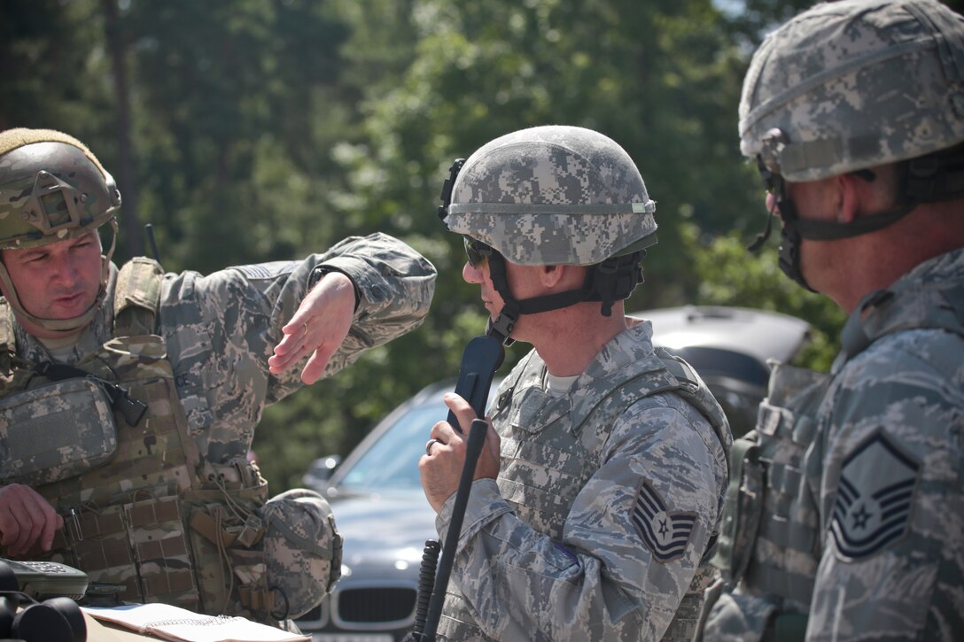 U.S. Air Force Chief Master Sgt. Robert Zaniewski, left, explains emergency close air support procedures to Airmen from the 177th Security Forces Squadron on July 16, 2014 at Grafenwoehr Training Area, Bavaria, Germany.  Zaniewski is the superintendent of the New Jersey Air National Guard's 227th Air Support Operations Squadron.  (U.S Air National Guard photo by Tech. Sgt. Matt Hecht/Released)