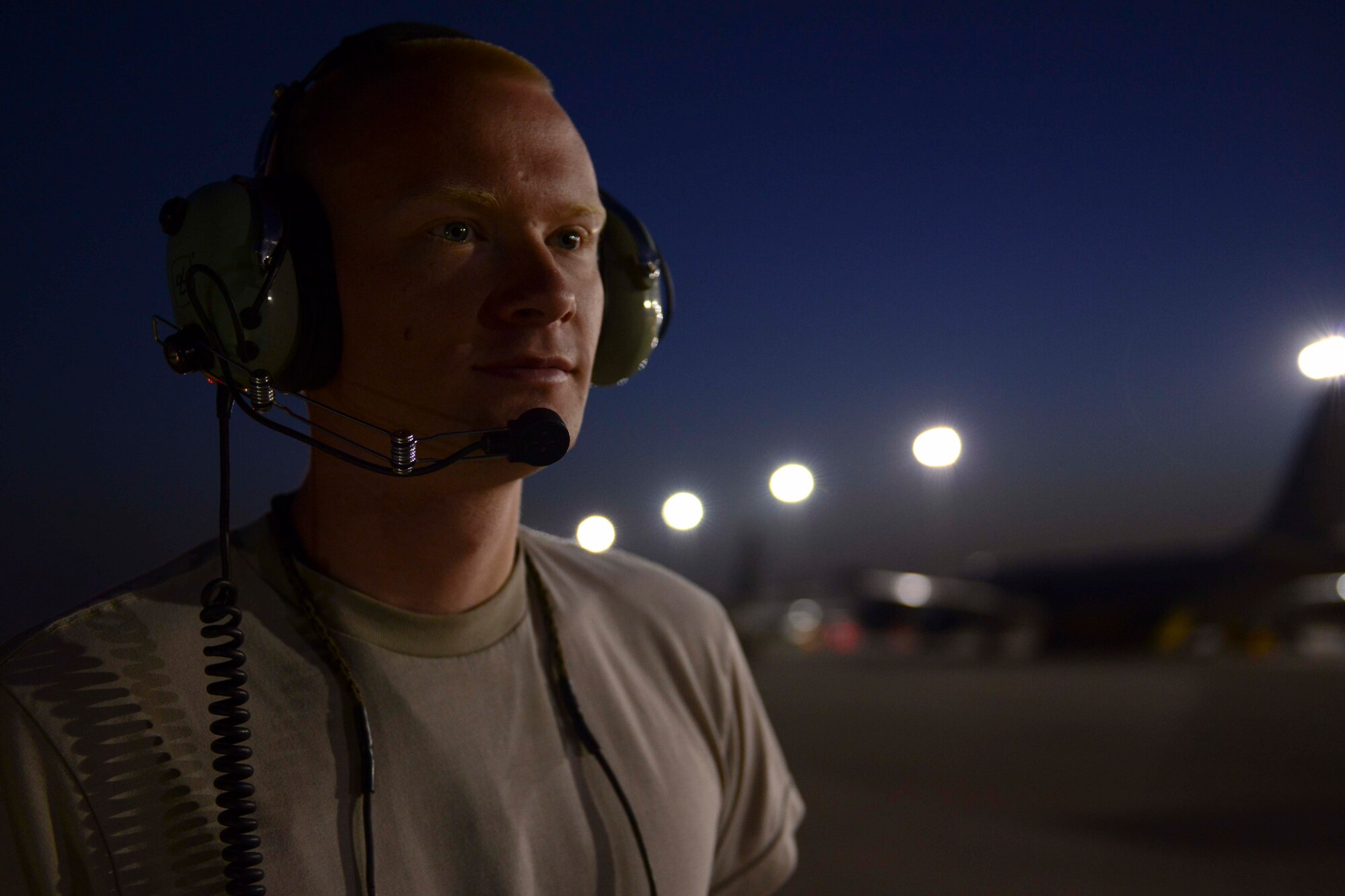 U.S. Air Force Airman 1st Class Olin Enzor, 763rd Aircraft Maintenance Unit electronics and environmental specialist, looks out at early morning maintenance operations at Al Udeid Air Base, Qatar, July 11, 2014. Enzor is deployed from Offut Air Force Base, Nebraska and hails from Macon, Georgia. (U.S. Air Force photo by Staff Sgt. Ciara Wymbs)