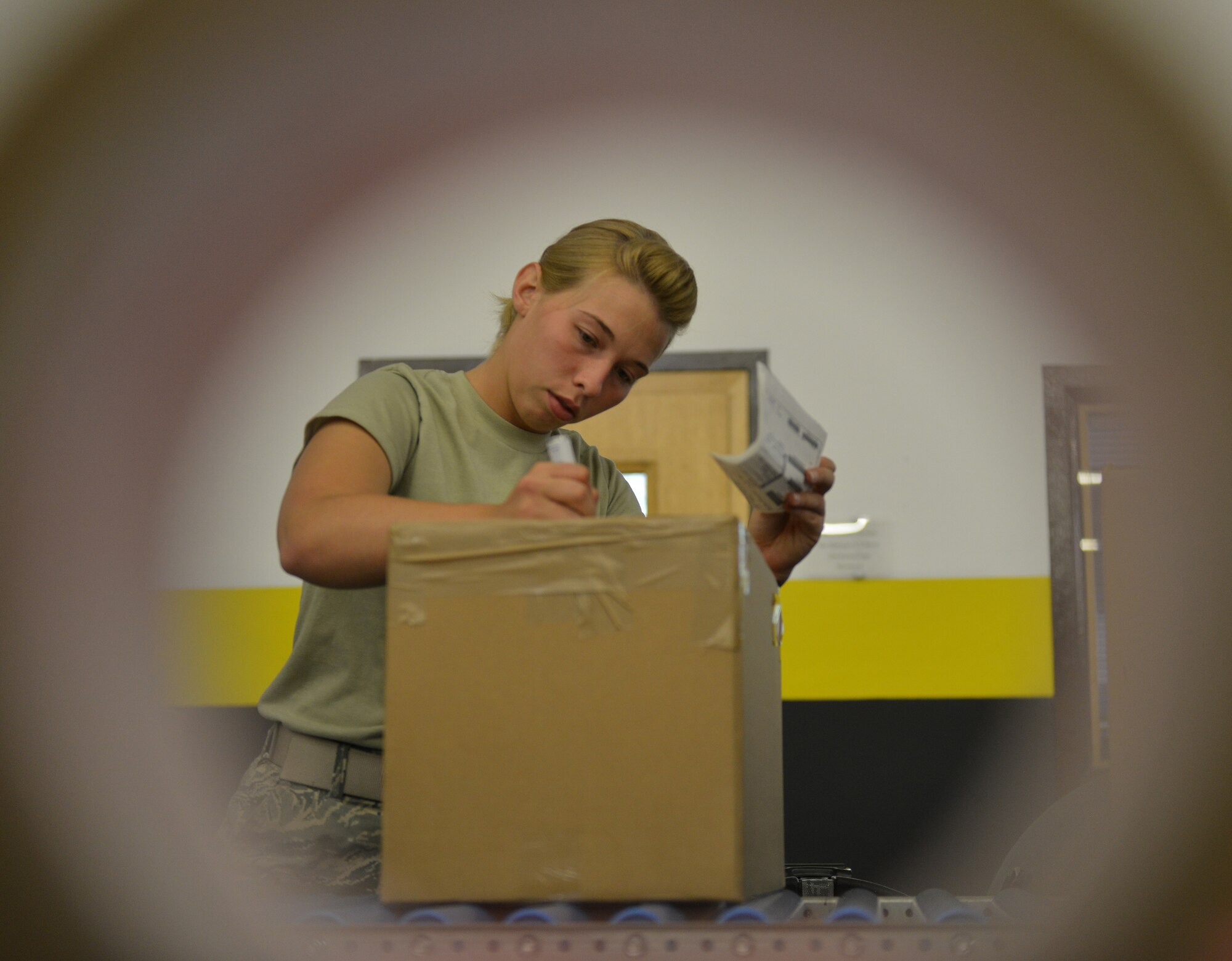 Airman 1st Class Alicia Wells, 86th Logistics Readiness Squadron traffic management operations specialist, prepares cargo for shipment July 23, 2014, Ramstein Air Base, Germany. The distribution division delivers equipment and other cargo to ensure Department of Defense missions are successful. (U.S. Air Force photo/Senior Airman Holly Mansfield)