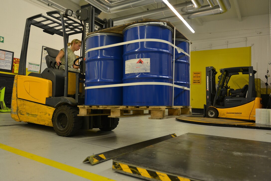Airman 1st Class Alicia Wells, 86th Logistics Readiness Squadron traffic management operations specialist, weighs barrels before they are shipped July 23, 2014, Ramstein Air Base, Germany. The distribution division delivers equipment and other cargo to ensure Department of Defense missions are successful. (U.S. Air Force photo/Senior Airman Holly Mansfield)