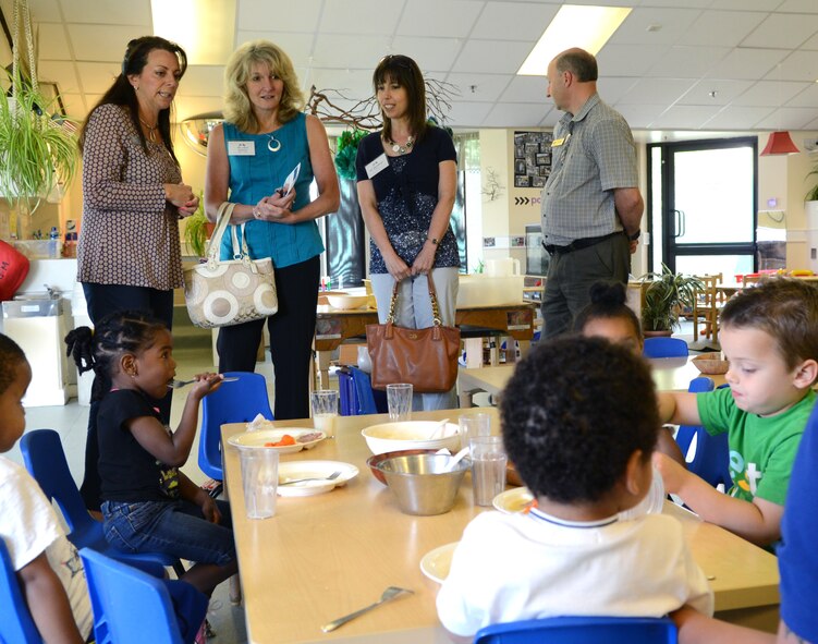 Cheryl Roberson, second from left, standing, wife of U.S. Air Force Lt. Gen. Darryl Roberson, 3rd Air Force commander, and Petra Marson, second from right, standing, wife of U.S. Air Force Chief Master Sgt. Mark Marson, 3rd Air Force command chief, visit the child development center July 22, 2014, during a base visit to RAF Mildenhall, England. Roberson and Marson visited multiple base organizations and received information on the mission and how the base operates on a daily basis. (U.S. Air Force photo/Airman 1st Class Dillon Johnston/Released)