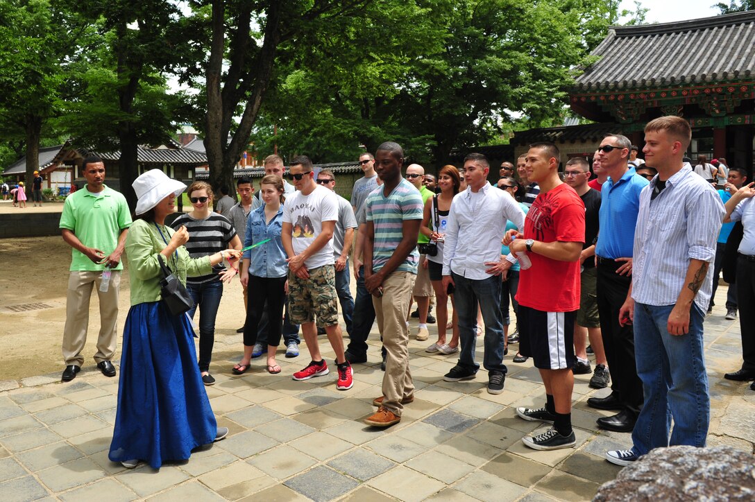 Yeon-han Park, Jeonju City English tour guide, leads Airmen from the 8th Fighter Wing on a walking tour of Jeonju City, following their participation in an Armistice Agreement anniversary ceremony, Jeonju, Republic of Korea, July 22, 2014. The tour was an opportunity for the Airmen to be immersed in the history, tradition and culture of Korea before and after the Korean War. (U.S. Air Force photo by 1st Lt. Earon Brown/Released)