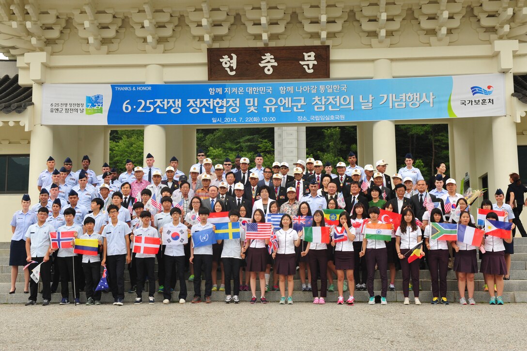 Attendees of the Armistice Agreement anniversary ceremony pose for a group photo following the conclusion of the ceremony at Imsil National Cemetery, Republic of Korea, July 22, 2014. The group was composed of Korean War veterans, Airmen from the 8th Fighter Wing at Kunsan Air Base, members of the ROK Ministry of Patriots and Veterans Affairs and middle school students from Gwangju City. (U.S. Air Force photo by 1st Lt. Earon Brown/Released)