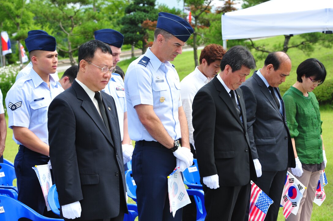 Col. Dennis Curran, 8th Mission Support Group commander, bows alongside Republic of Korea Ministry of Patriots and Veterans Affairs representatives for a moment of silence during an Armistice Agreement anniversary ceremony at Imsil National Cemetery, Republic of Korea, July 22, 2014. The MPVA invited the 8th Fighter Wing to participate in the event as representatives of the U.S. military. (U.S. Air Force photo by 1st Lt. Earon Brown/Released)