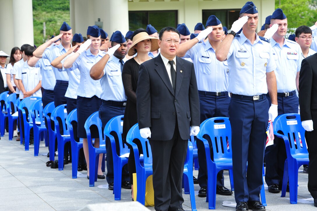 Wolf Pack Airmen from the 8th Fighter Wing at Kunsan Air Base render a salute as the American national anthem plays during an Armistice Agreement anniversary ceremony at Imsil National Cemetery, Republic of Korea, July 22, 2014. The group was led by Col. Dennis Curran, 8th Mission Support Group commander, who was accompanied by Airmen representing each group and the wing staff agencies of the 8th FW. (U.S. Air Force photo by 1st Lt. Earon Brown/Released)