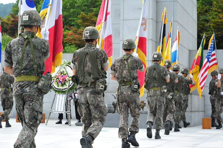 Republic of Korea soldiers with the 35th Infantry Division post the flags of U.N. member nations involved in the Korean War at the start of an Armistice Agreement anniversary ceremony at Imsil National Cemetery, Republic of Korea, July 22, 2014. 8th Fighter Wing Airmen were invited to attend the event and actively take part in several of the official proceedings. (U.S. Air Force photo by 1st Lt. Earon Brown/Released)