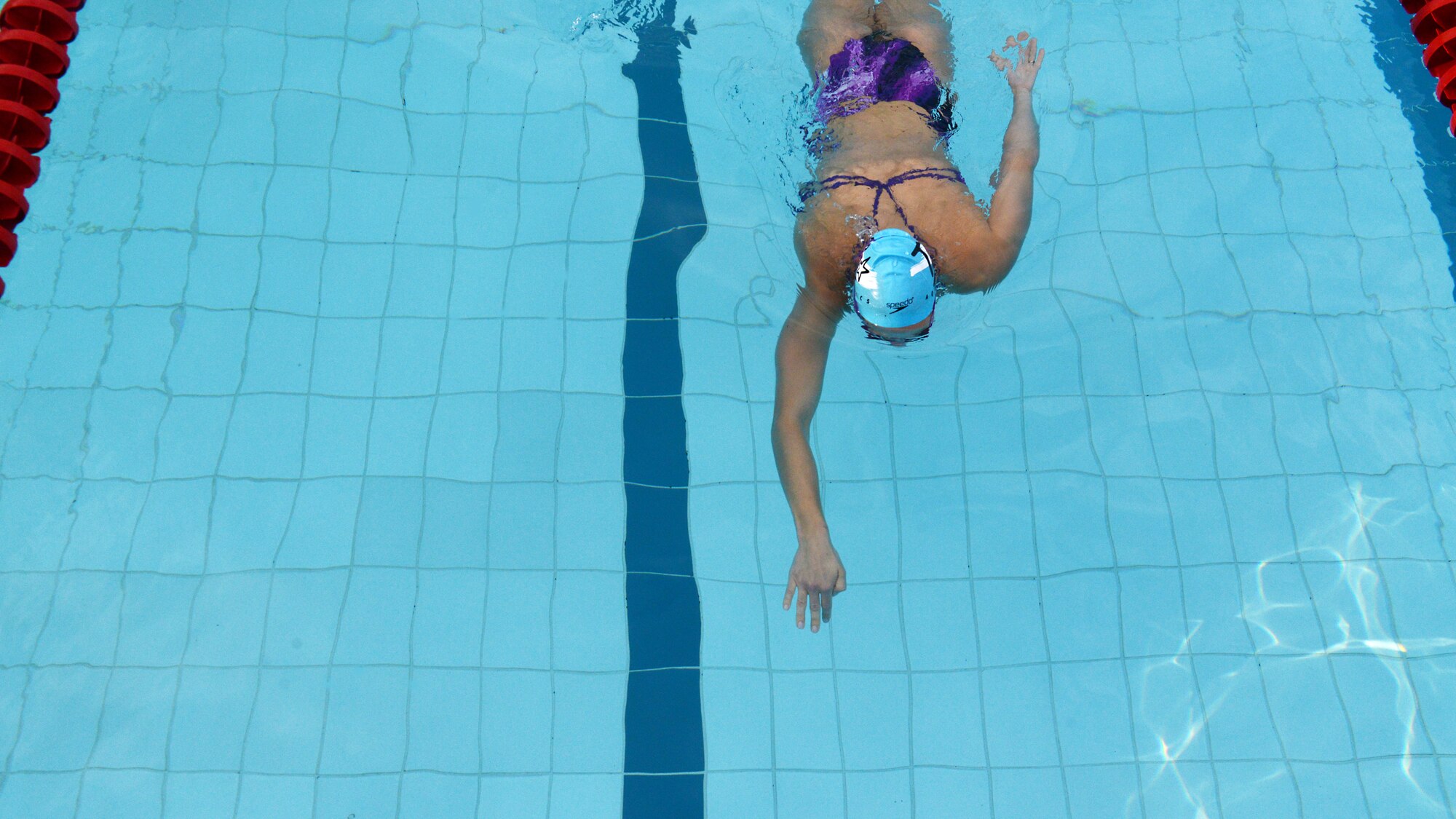 Ashley Walters, U.S. Master Swimming member, reaches for the wall after a 50 meter sprint, July 23, 2014, at Aviano Air Base, Italy. USMS is a national membership-operated nonprofit organization that gives adult swimmers an opportunity to swim in a controlled program with other adult swimmers. (U.S. Air Force photo/Airman 1st Class Ryan Conroy) 

