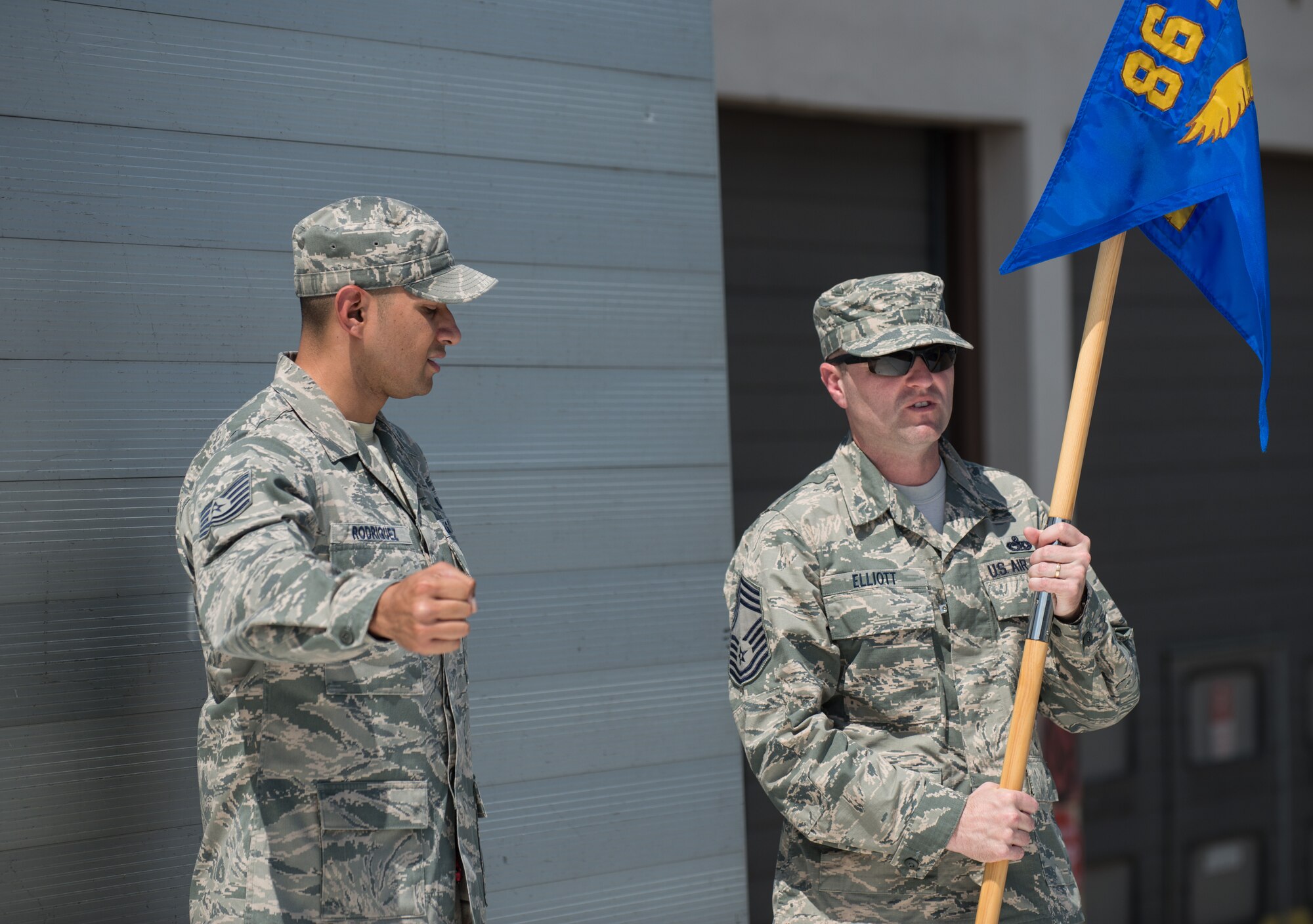 Tech. Sgt. Raul Rodriguez, 86th Airlift Wing protocol member, helps position Chief Master Sgt. Paul Elliott, 86th Logistics Readiness Group command chief, during a change of command dry-run July 17, 2014, at Ramstein Air Base, Germany. The wing protocol office is made up of four Airmen who provide support to approximately 22,000 military members and Department of Defense civilians. (U.S. Air Force photo/Senior Airman Jonathan Stefanko)