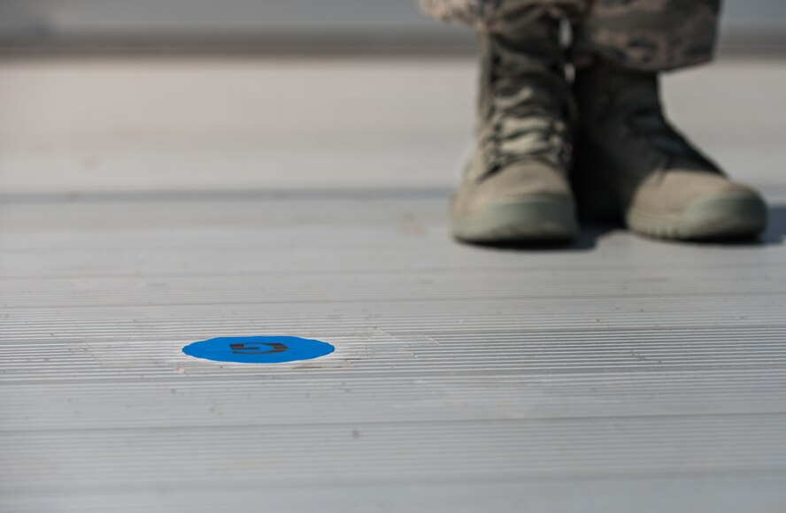 Chief Master Sgt. Paul Elliott, 86th Logistics Readiness Group command chief, finds his position during a change of command dry-run with the 86th Airlift Wing protocol team July 17, 2014, at Ramstein Air Base, Germany. The wing protocol office is made up of four Airmen who provide support to approximately 22,000 military members and Department of Defense civilians. (U.S. Air Force photo/Senior Airman Jonathan Stefanko)