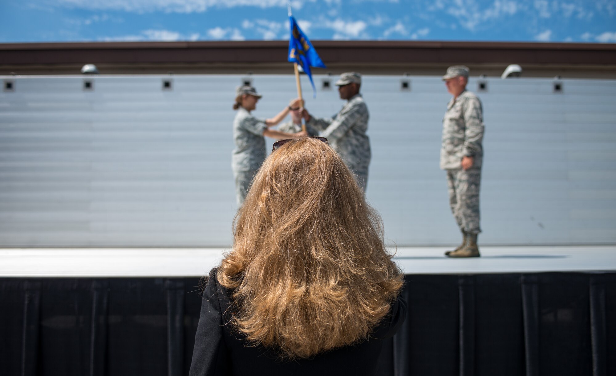 Teresa Bracher, 86th Airlift Wing chief of protocol, watches a change of command dry-run July 17, 2014 on Ramstein Air Base, Germany. The wing protocol office is made up of four Airmen who provide support to approximately 22,000 military members and Department of Defense civilians. (U.S. Air Force photo/Senior Airman Jonathan Stefanko)