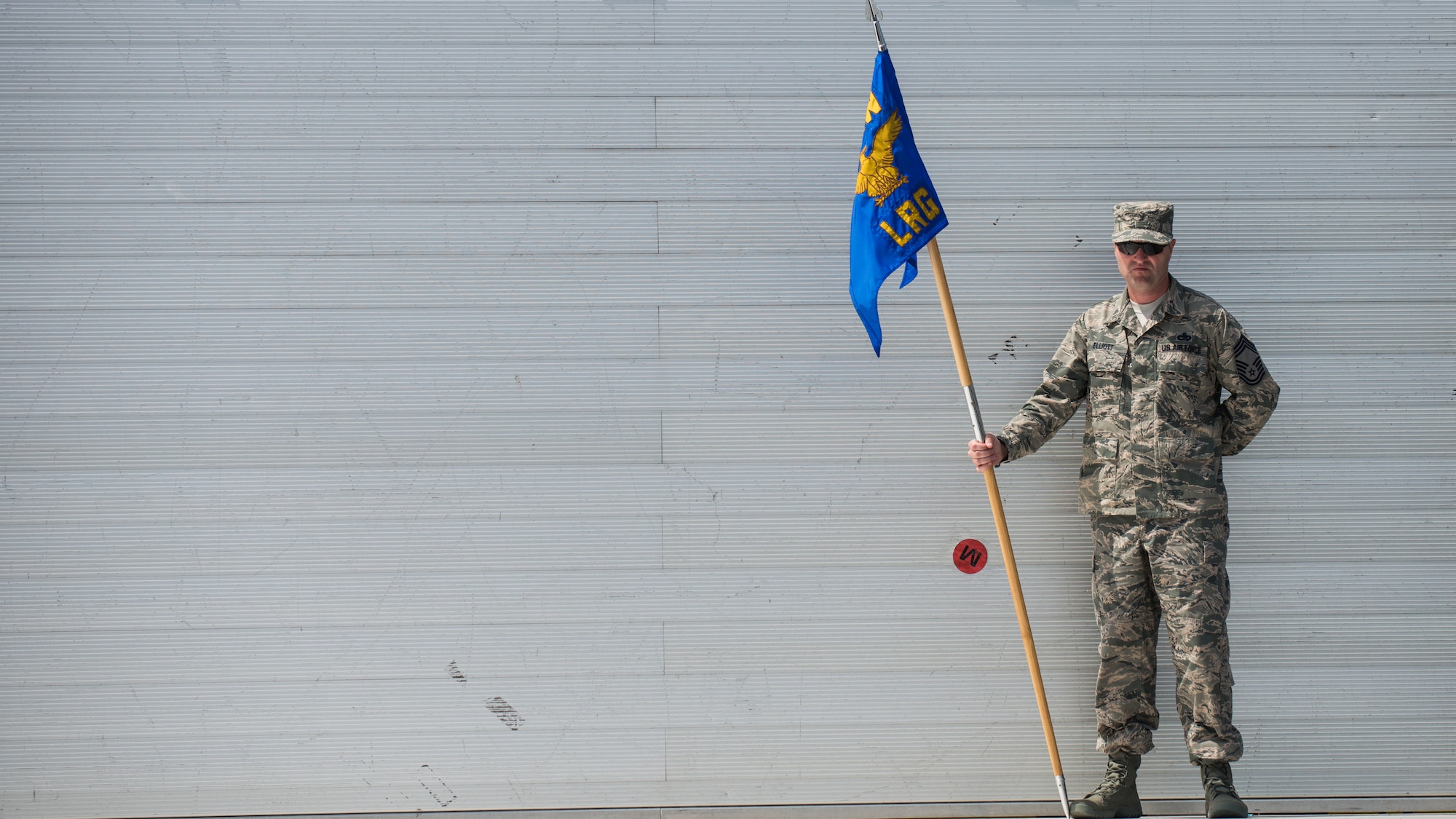 Chief Master Sgt. Paul Elliott, 86th Logistics Readiness Group command chief, gets into place during a change of command dry-run with the 86th Airlift Wing protocol team July 17, 2014, at Ramstein Air Base, Germany. The wing protocol office is made up of four Airmen who provide support to approximately 22,000 military members and Department of Defense civilians. (U.S. Air Force photo/Senior Airman Jonathan Stefanko)
