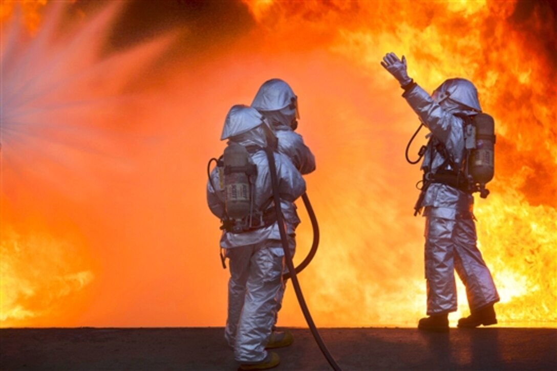 Marines train to fight fires and rescue aircraft on Marine Corps Air Station Beaufort, S.C., July 22, 2014. The Marines are assigned to Aircraft Rescue and Fire Fighting. The training ensures familiarity with the gear and increases proficiency and response times within the unit.