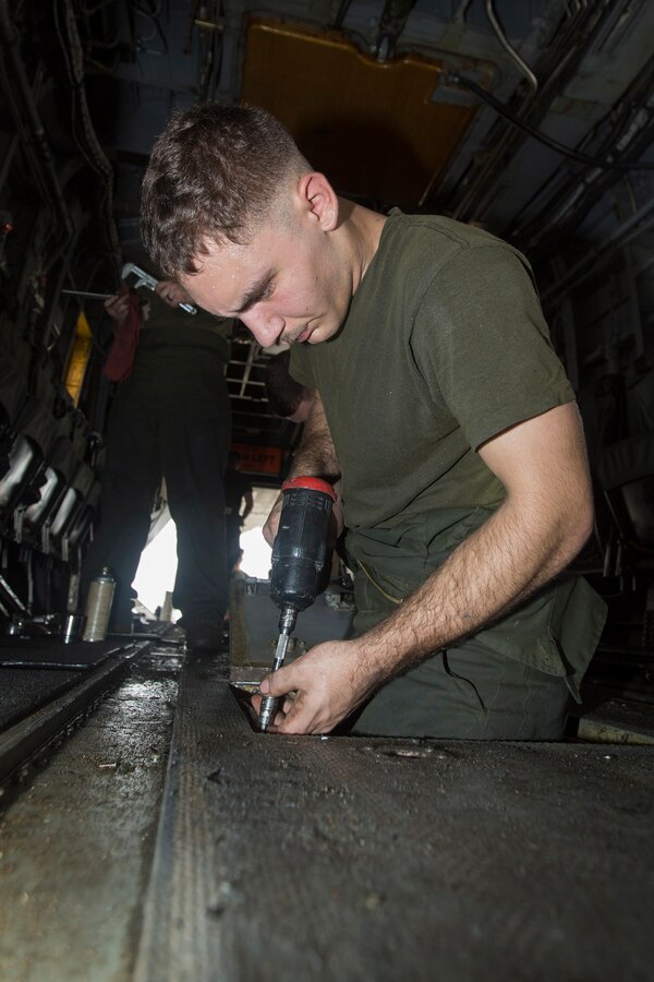 U.S. 5TH FLEET AREA OF RESPONSIBILITY (July 18, 2014) U.S. Marine Corps Cpl. Zachary Yenney, Marine Medium Tiltrotor Squadron (VMM) 263 (Reinforced), 22nd Marine Expeditionary Unit (MEU), CH-53E Super Stallion airframe mechanic and native of Freeport, Ill., performs maintenance on a Super Stallion aboard the amphibious transport dock ship USS Mesa Verde (LPD 19). The 22nd MEU is deployed with the Bataan Amphibious Ready Group as a theater reserve and crisis response force throughout U.S. Central Command and the U.S. 5th Fleet area of responsibility. (U.S. Marine Corps photo by Cpl. Manuel A. Estrada/Released)