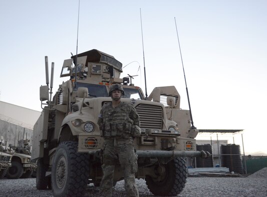 Senior Airman Julian Rangel stands by one of the mine-resistant ambush-protected vehicles that two Air Force quick reaction forces used while defending a forward operating base from a Taliban attack July 17 near Kabul Airport and Afghan air force base, Afghanistan. Rangel, who was asleep at the time the attack began, responded to the fight in shorts, t-shirt and tennis shoes under his body armor. He served as a gunner on the vehicle and laid down about 400 rounds of suppressive fire with an M240B medium machine gun during the more than four-hour firefight.  (U.S. Air Force photo/Senior Master Sgt. Mike Hammond)